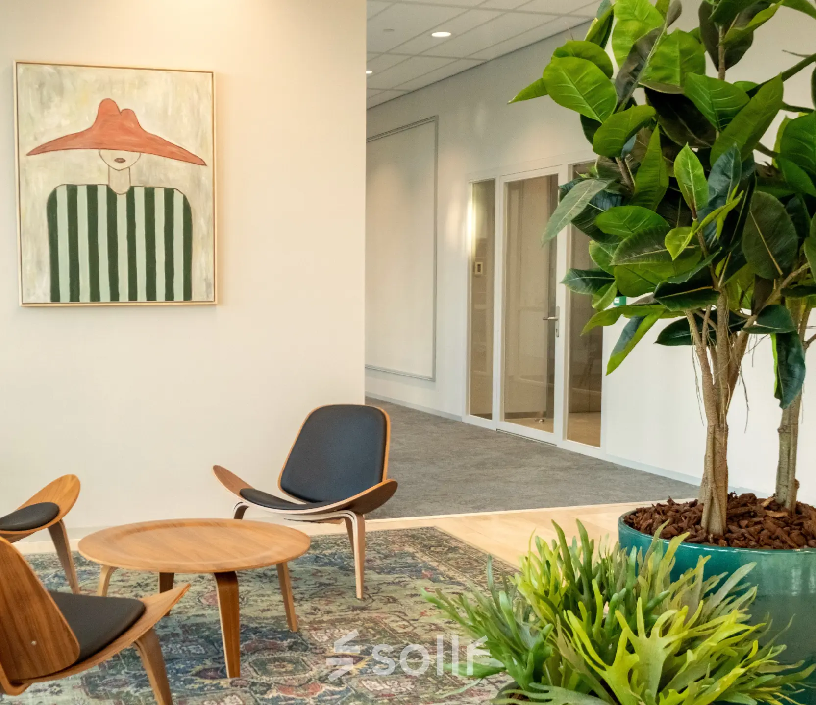 Inviting workspace at David Ricardostraat 1 in Amsterdam Riekerpolder features modern furniture and lush greenery, ideal for office space rental.