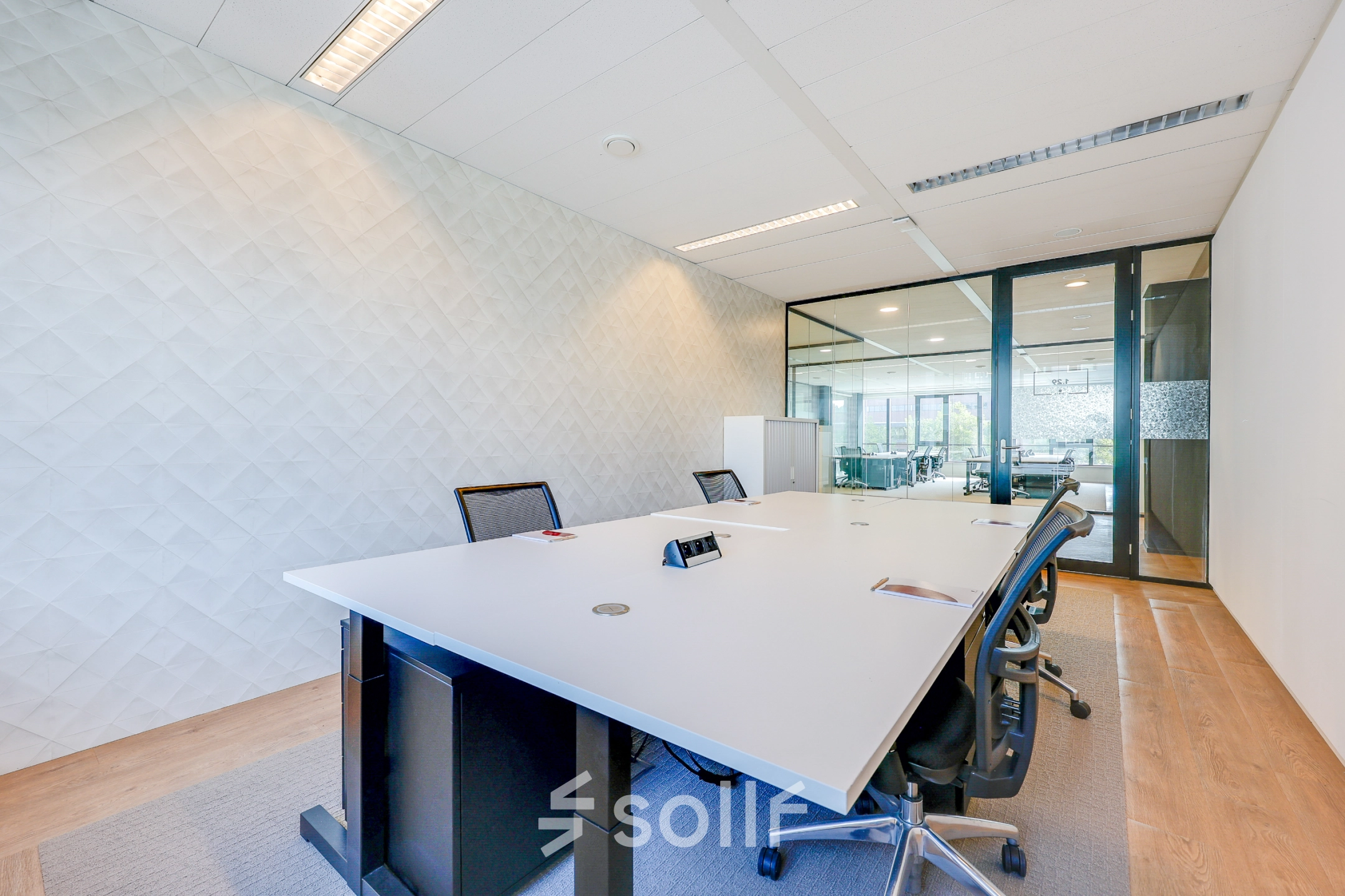 Bright and modern office space with a large meeting table and chairs, ideal for office space rental at Thomas R. Malthusstraat, Amsterdam Riekerpolder.