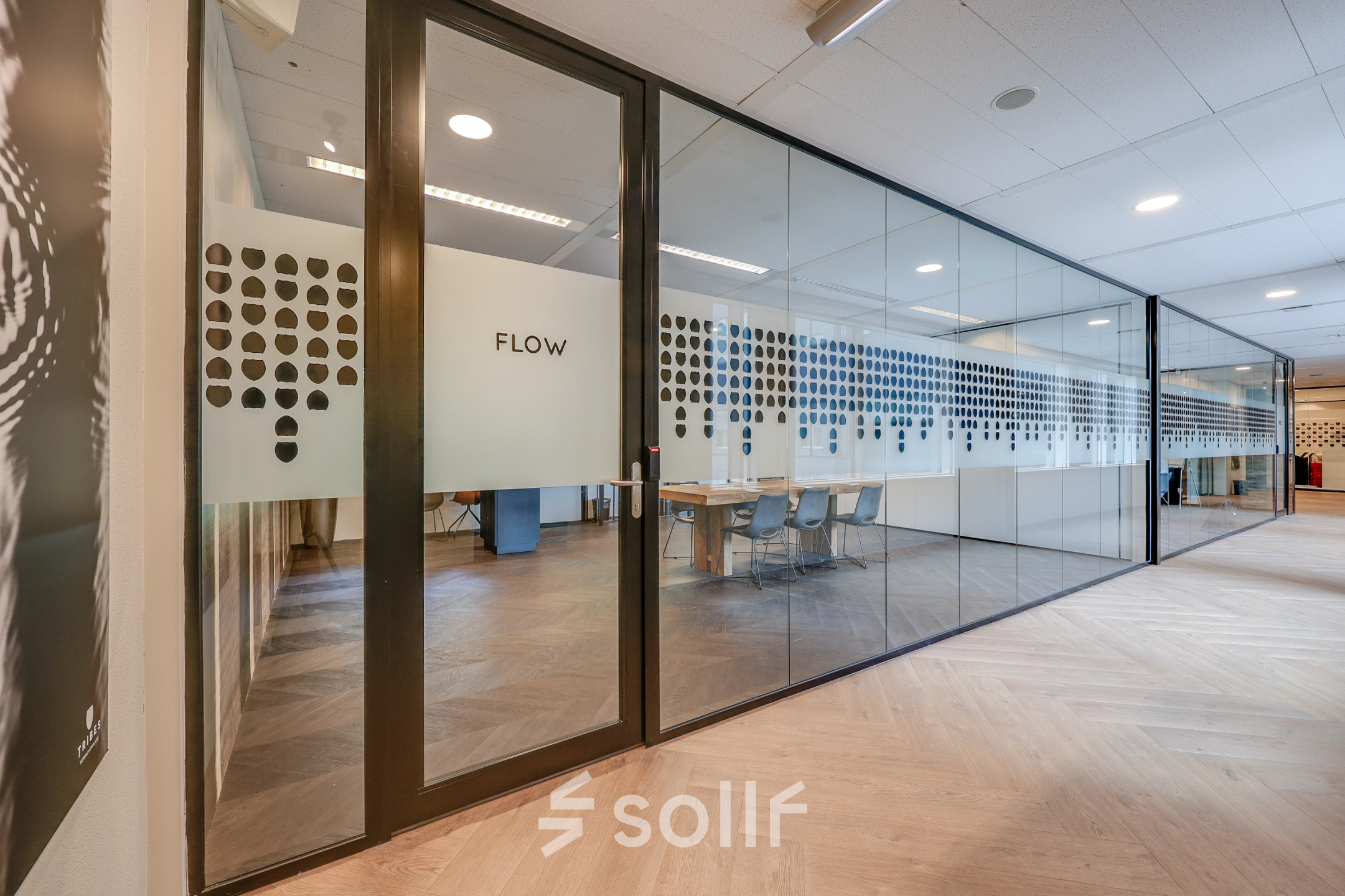 Modern office space with glass walls, featuring stylish conference rooms available for office space rental in Amsterdam Riekerpolder, Thomas R. Malthusstraat 1-3.