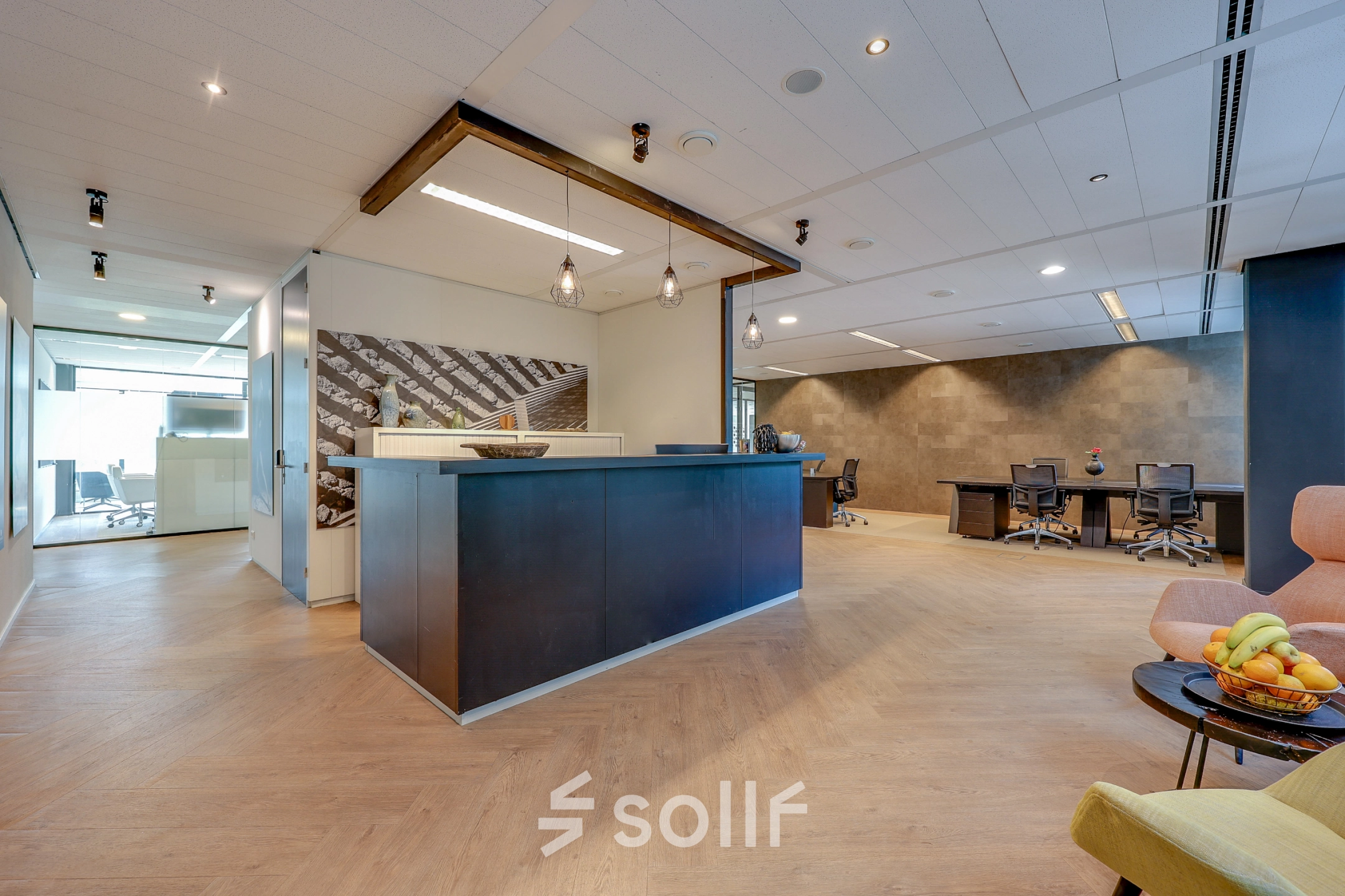 Modern office space for rent at Thomas R. Malthusstraat 1-3, Amsterdam Riekerpolder, featuring a stylish reception area with a sleek desk and contemporary furnishings.