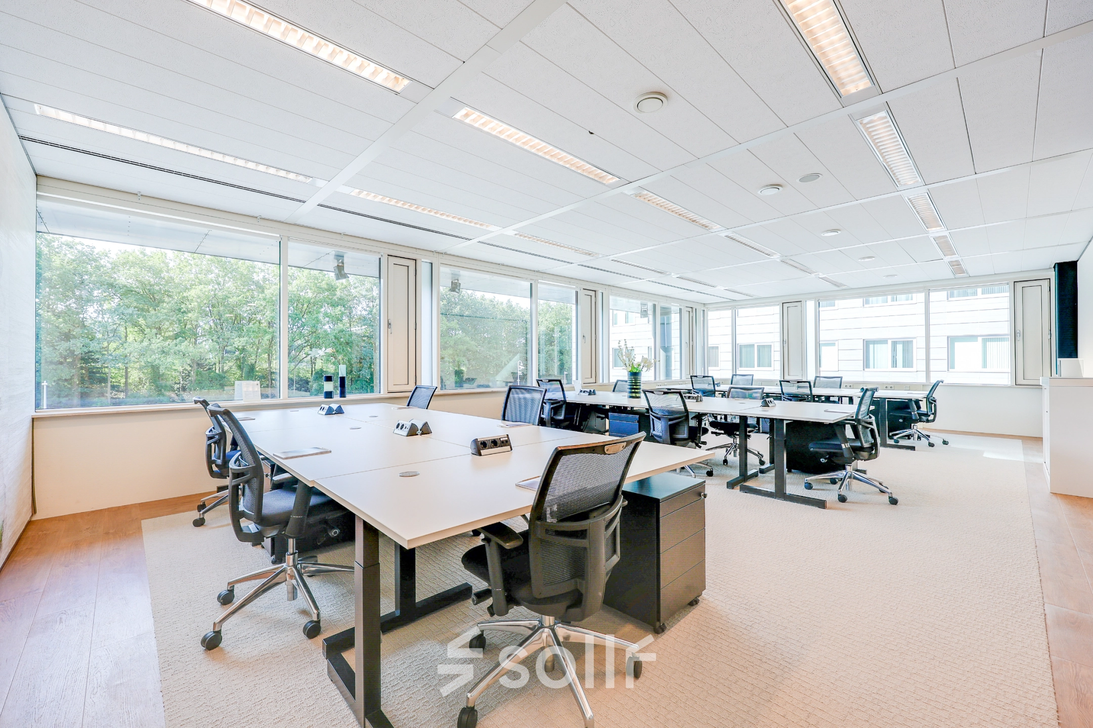 Spacious and bright office space with modern furniture at Thomas R. Malthusstraat 1-3, ideal for rent office space in Amsterdam Riekerpolder. Large windows let in plenty of natural light.