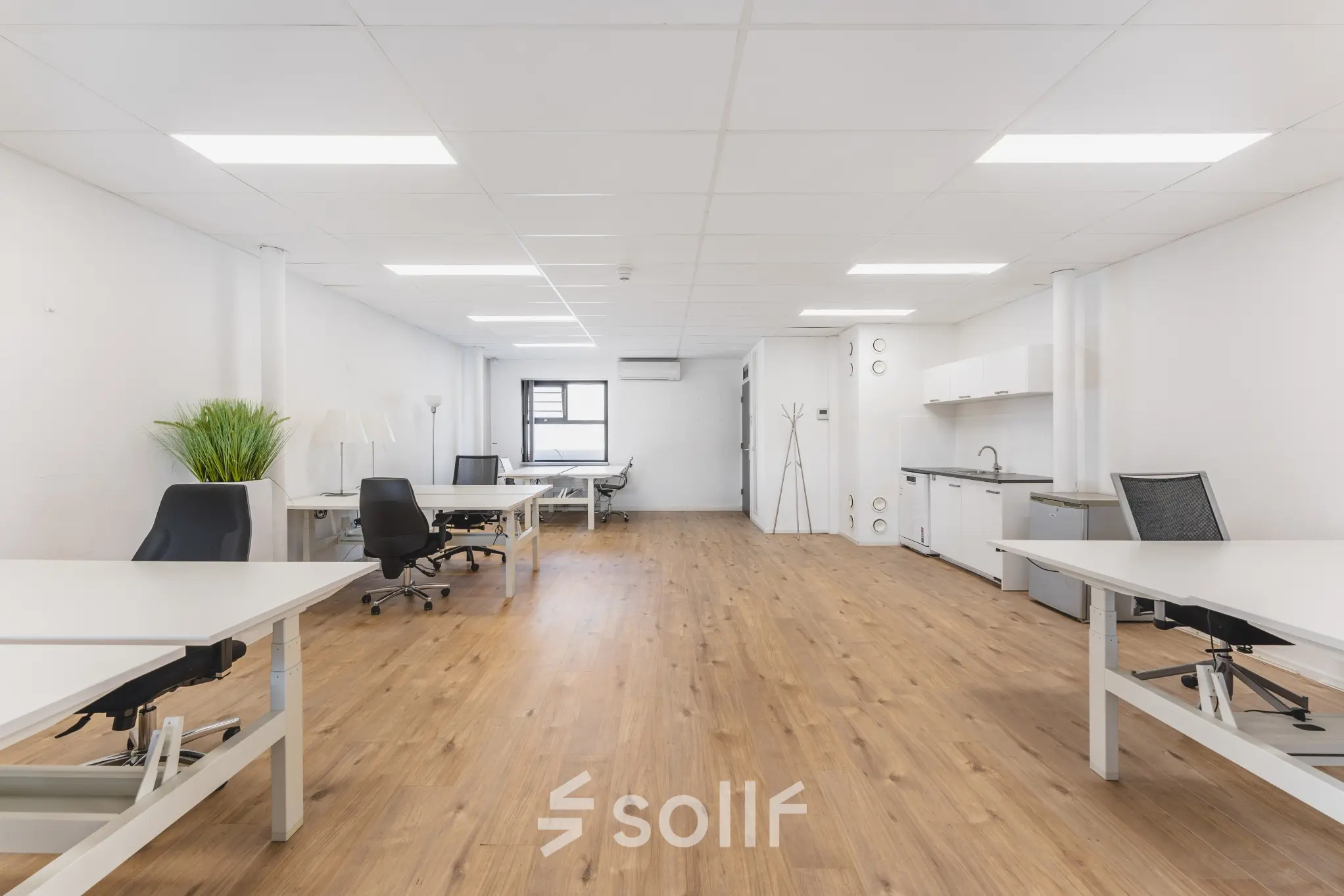 Modern office space at Arlandaweg 92, Amsterdam Sloterdijk, featuring wooden flooring, white walls, and a kitchenette, ideal for businesses seeking office space rental.