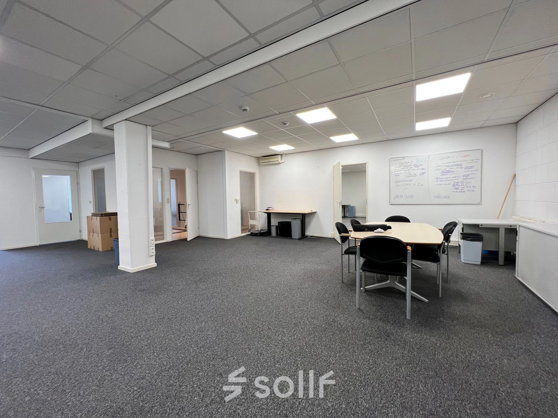 Spacious office interior at Contactweg 131, Amsterdam Sloterdijk, suitable for office space rental with seating and work tables.
