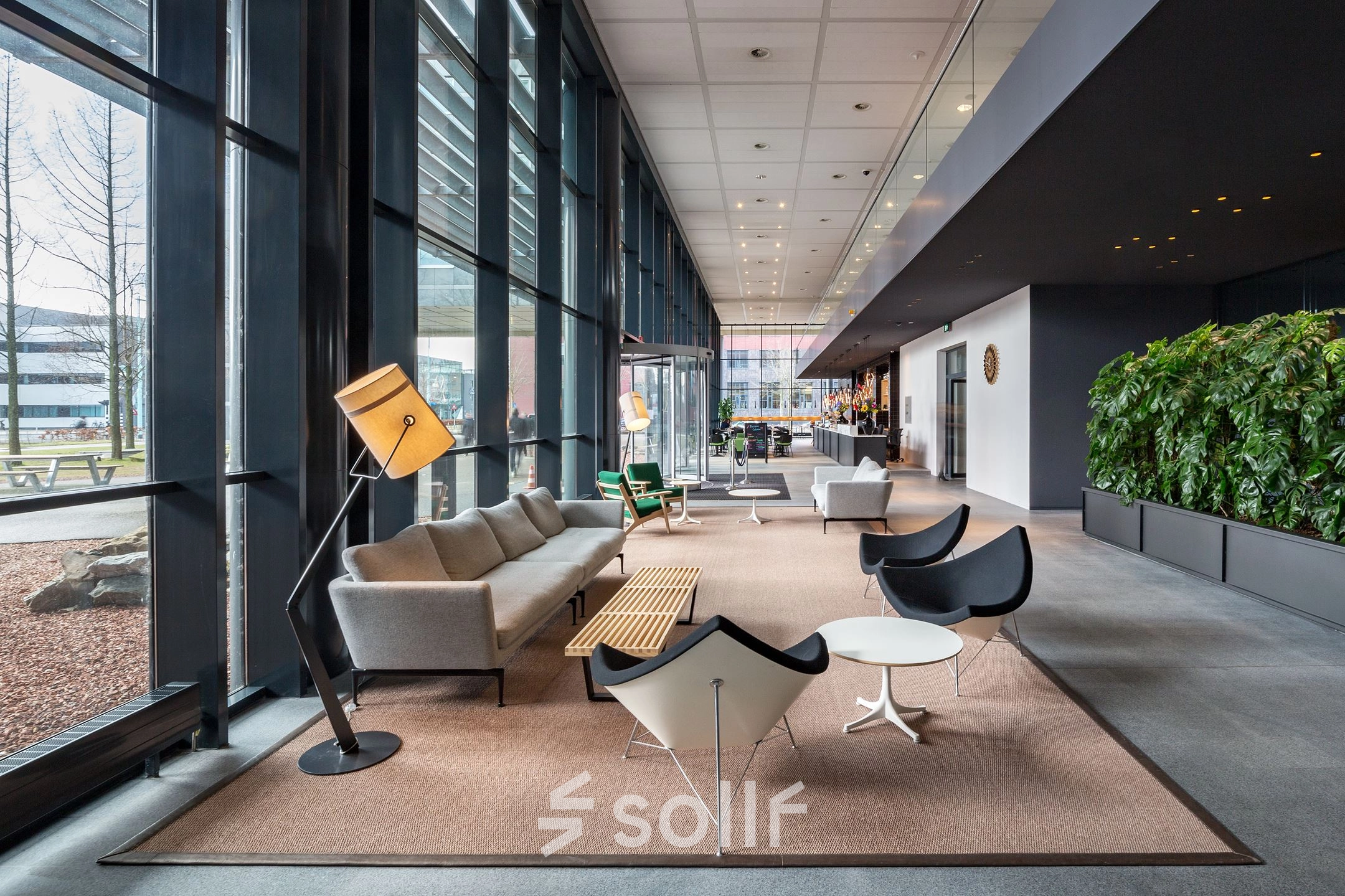 Modern office space with stylish furniture and large windows at Kingsfordweg 43, Amsterdam Sloterdijk, available for rent. Perfect for business professionals seeking a bright, open area for workspaces.