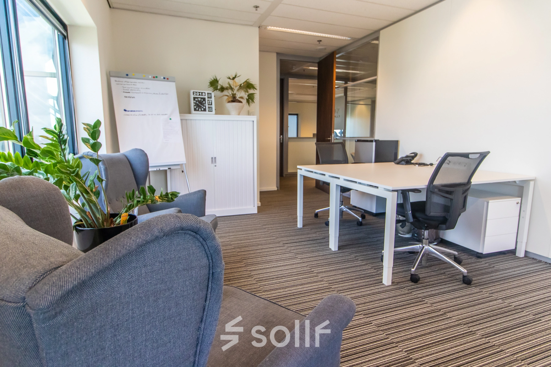 Interior office space at Radarweg 29, Amsterdam Sloterdijk, featuring modern furnishings with desks, chairs, and plants, ideal for office space rental.
