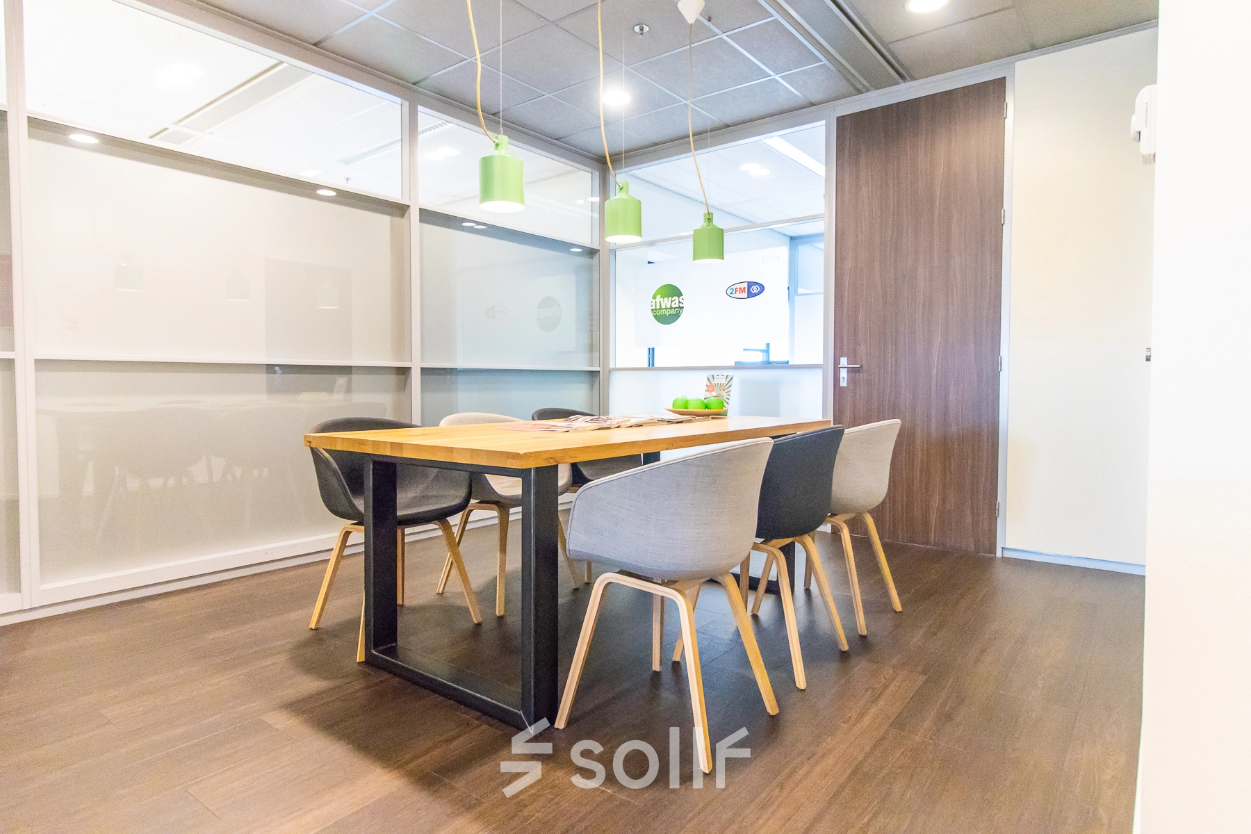 Bright office space with a wooden table and stylish chairs available for rent at Radarweg 29, Amsterdam Sloterdijk.