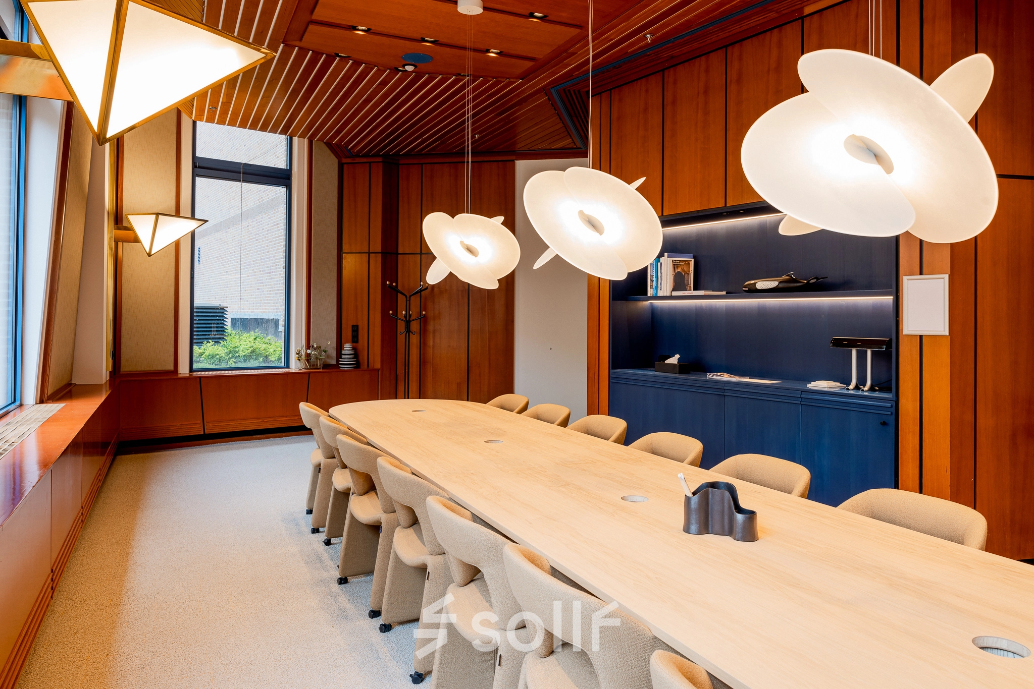 Modern office to rent at Bijlmerplein 888, Amsterdam South East, featuring a stylish conference room with elegant lighting and contemporary furnishings.