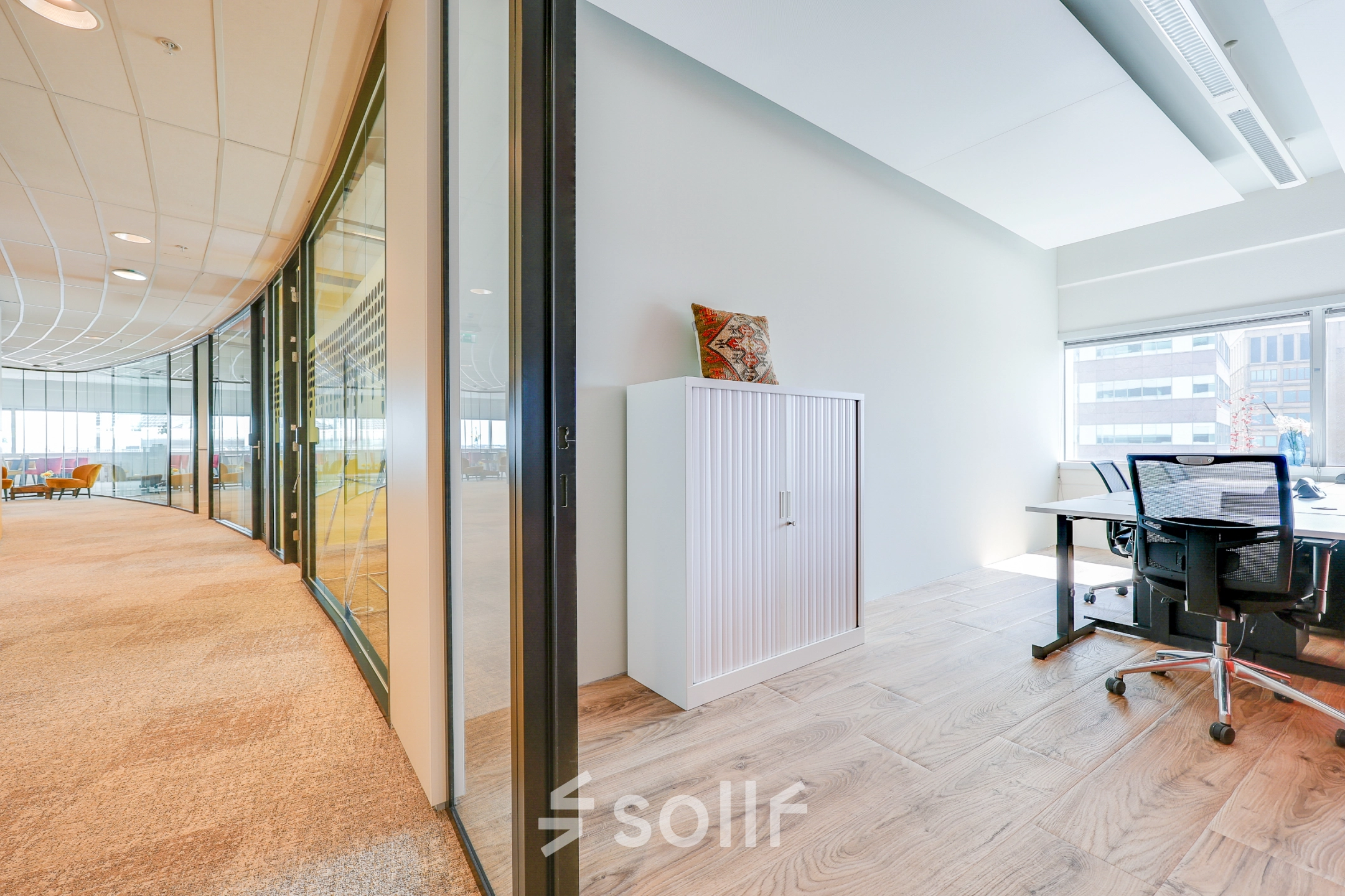 Bright office space for rent with large windows and modern furnishings, located at De Entree 99-197 in Amsterdam South East.