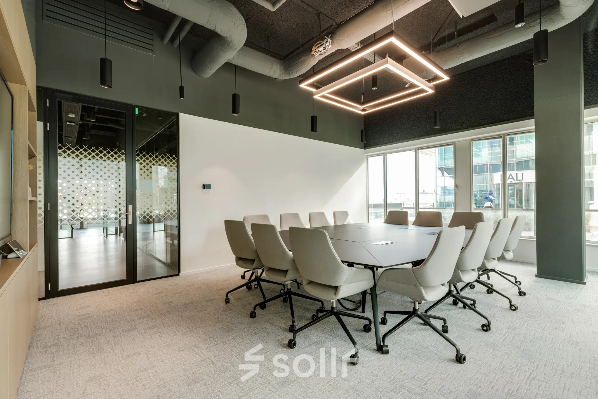 Modern conference room in Amsterdam South East, Herikerbergweg 288, featuring a large table and stylish lighting, ideal for office space rental.