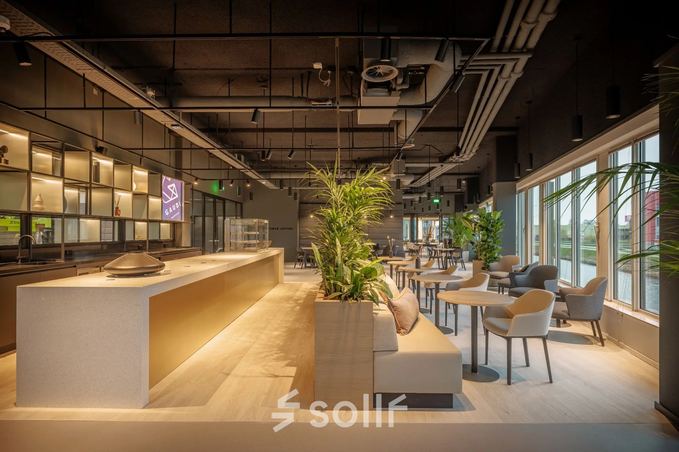 Modern furnished office space with seating area and natural light in Amsterdam South East, ideal for office space rental.