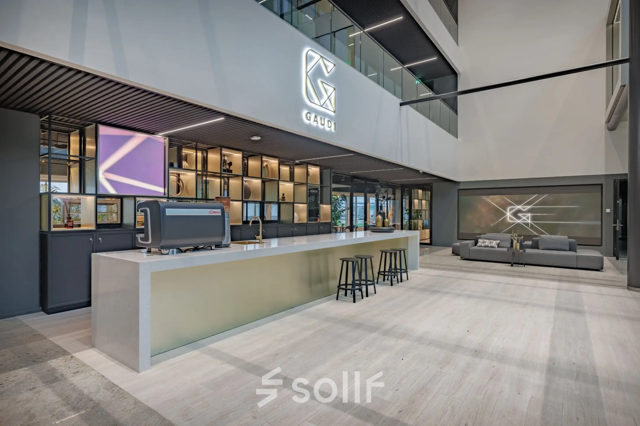 Modern office space available for rent at Herikerbergweg 290, Amsterdam South East, featuring a stylish reception area with seating and a sleek counter.