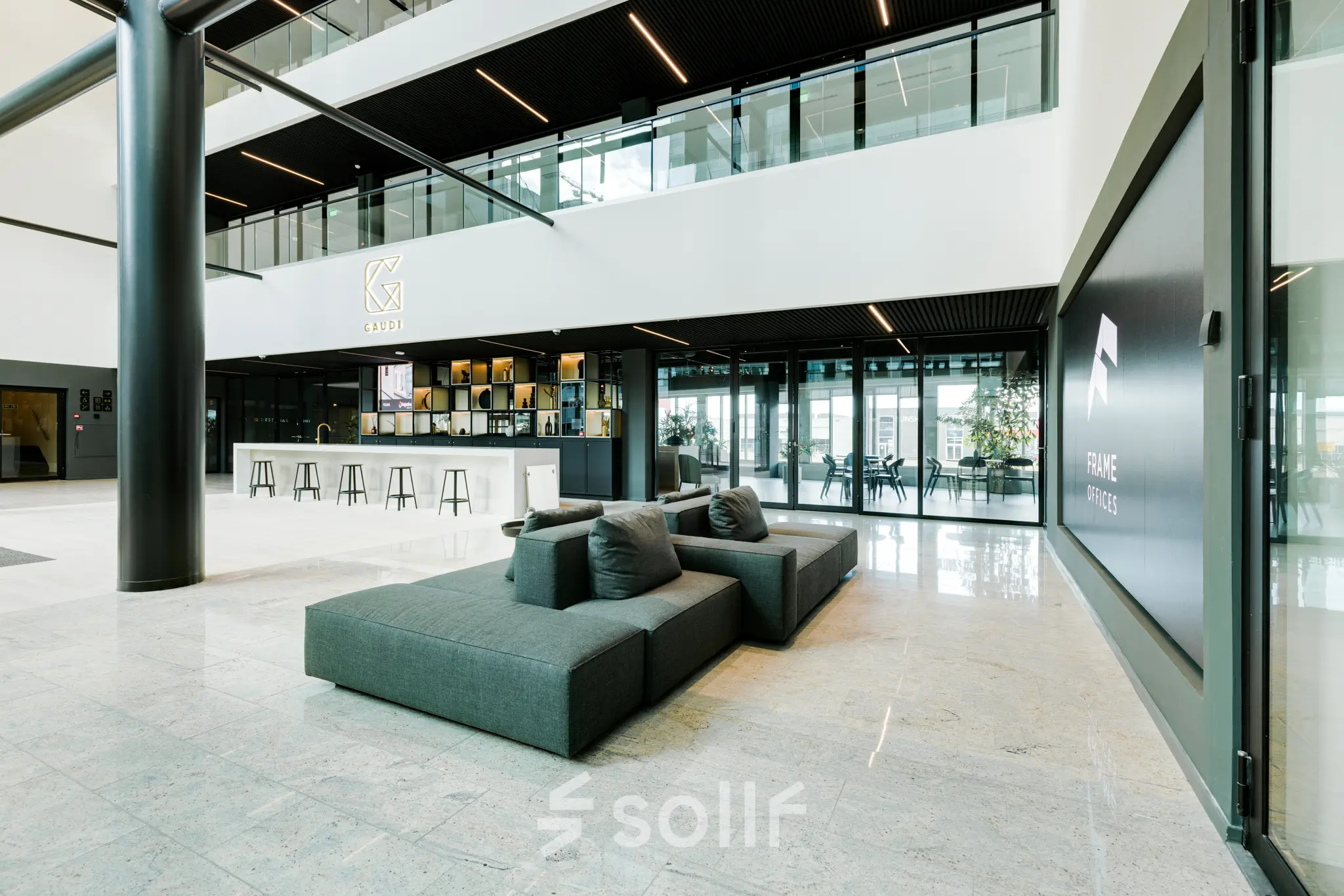 Modern office entrance with seating and a sleek design at Herikerbergweg 290, ideal for office space rental in Amsterdam South East.