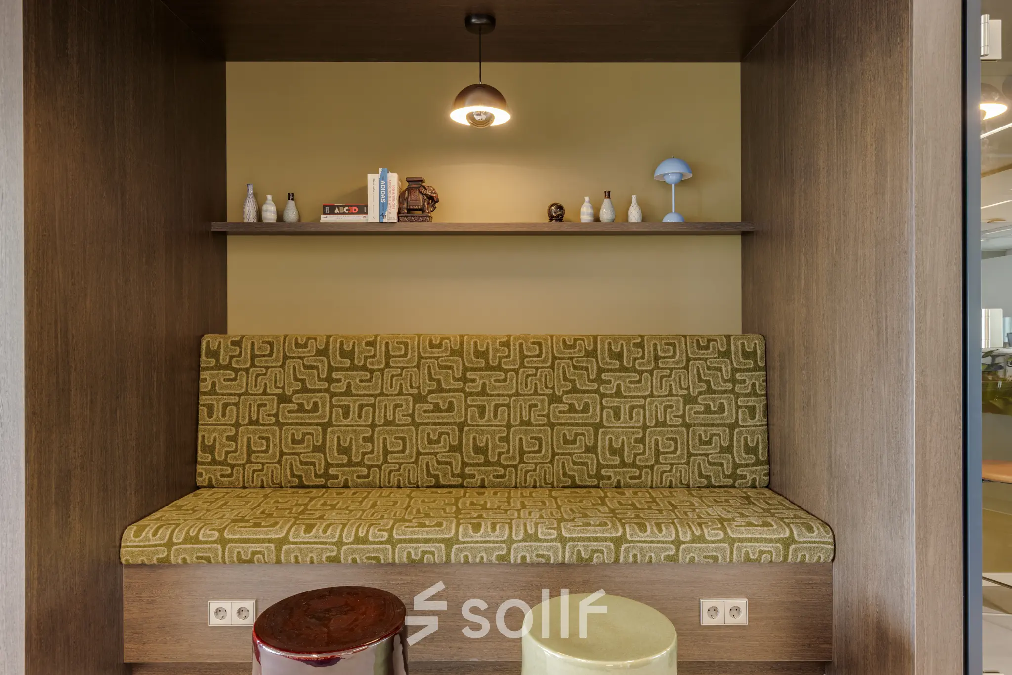 Cozy nook with patterned seating and shelves at Herikerbergweg 290, ideal for office space rental in Amsterdam South East.