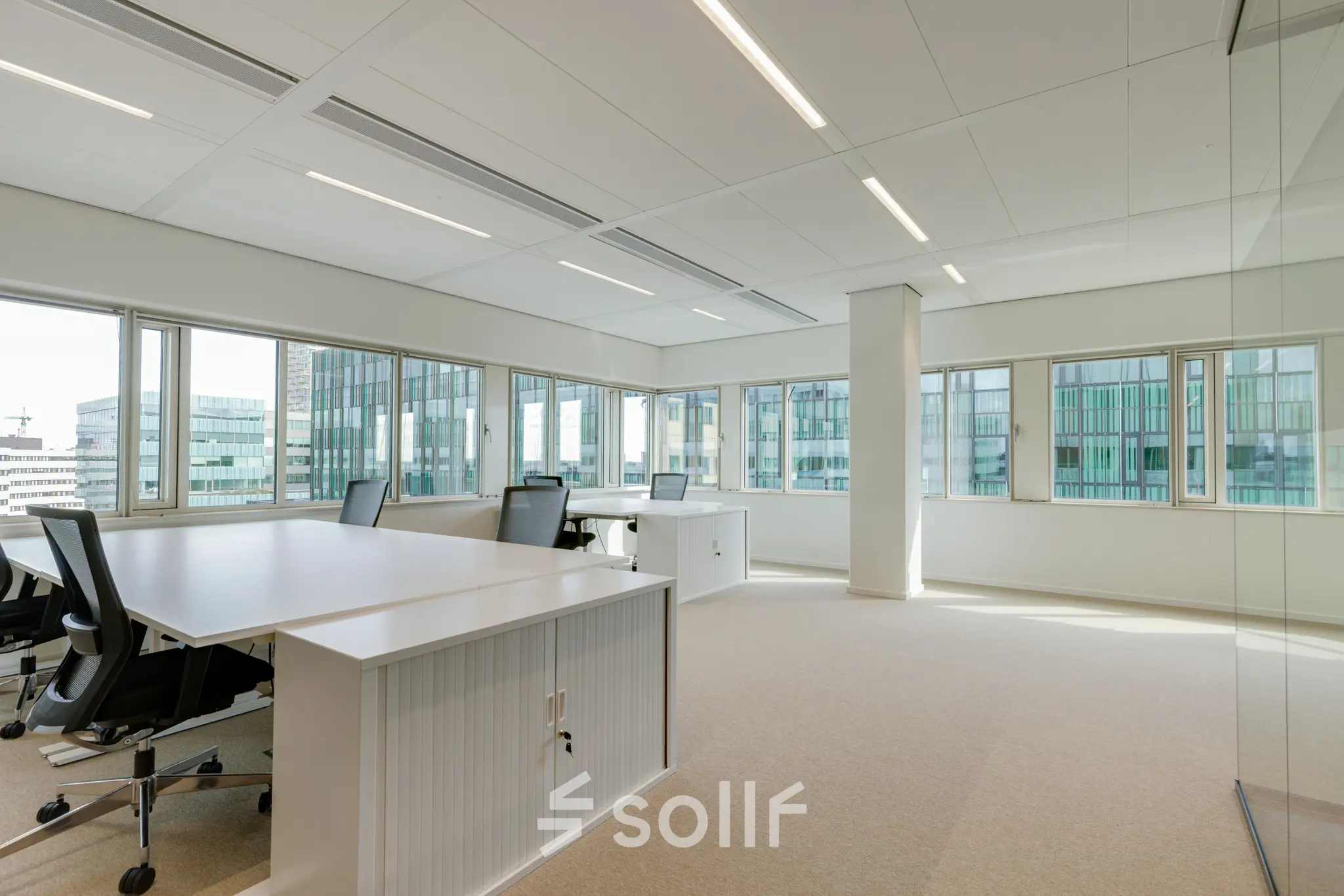 Bright office space rental at Herikerbergweg 290, Amsterdam South East, featuring modern desks and chairs in a light-filled room.