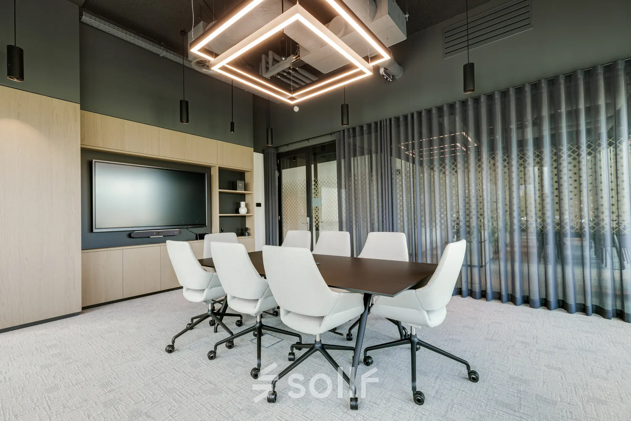 Modern conference room at Herikerbergweg 290, Amsterdam South East, featuring a sleek table and chairs, ideal for office space rental.