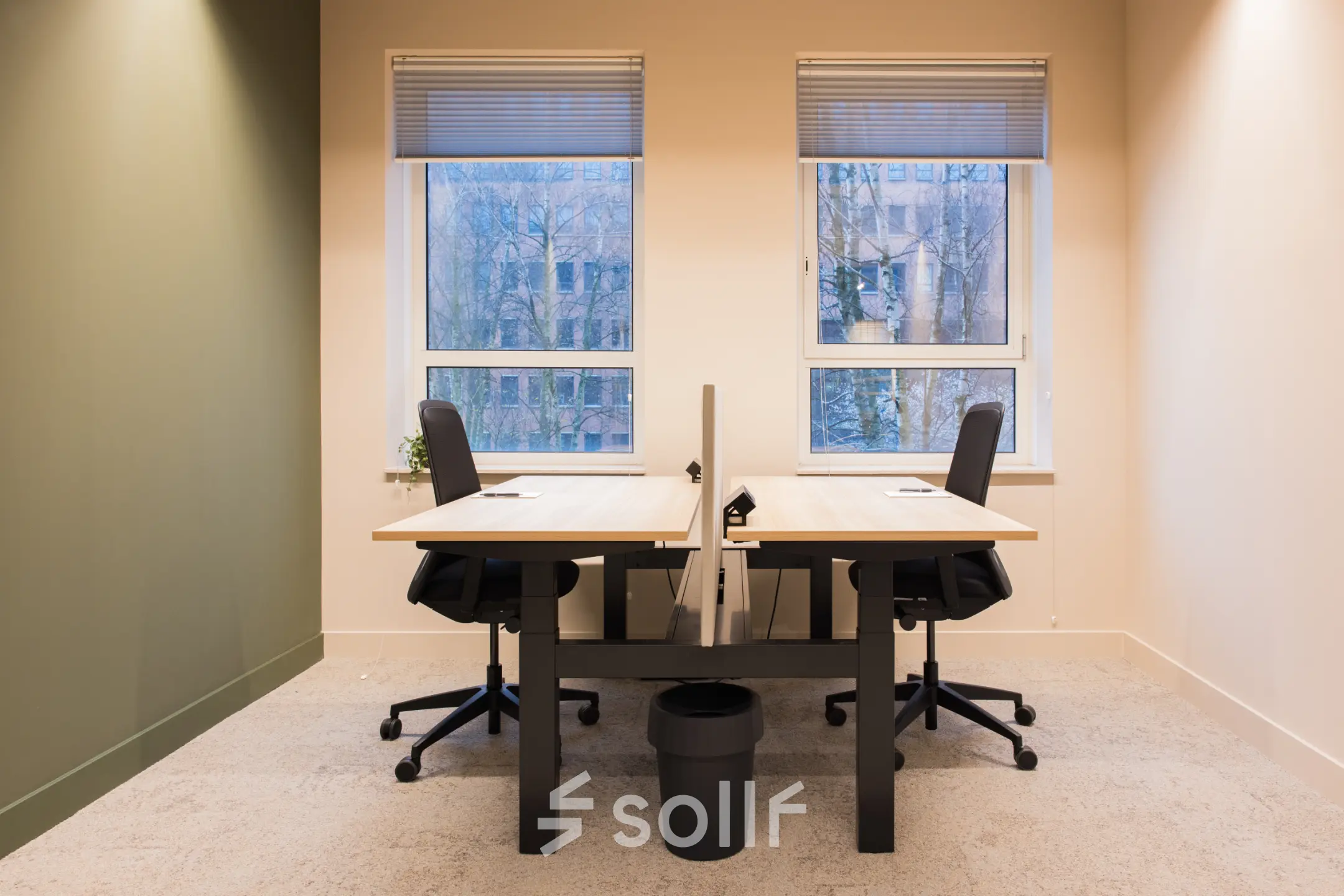 Bright office space with two desks, modern chairs, and large windows, available for rental at Hullenbergweg, Amsterdam South East.