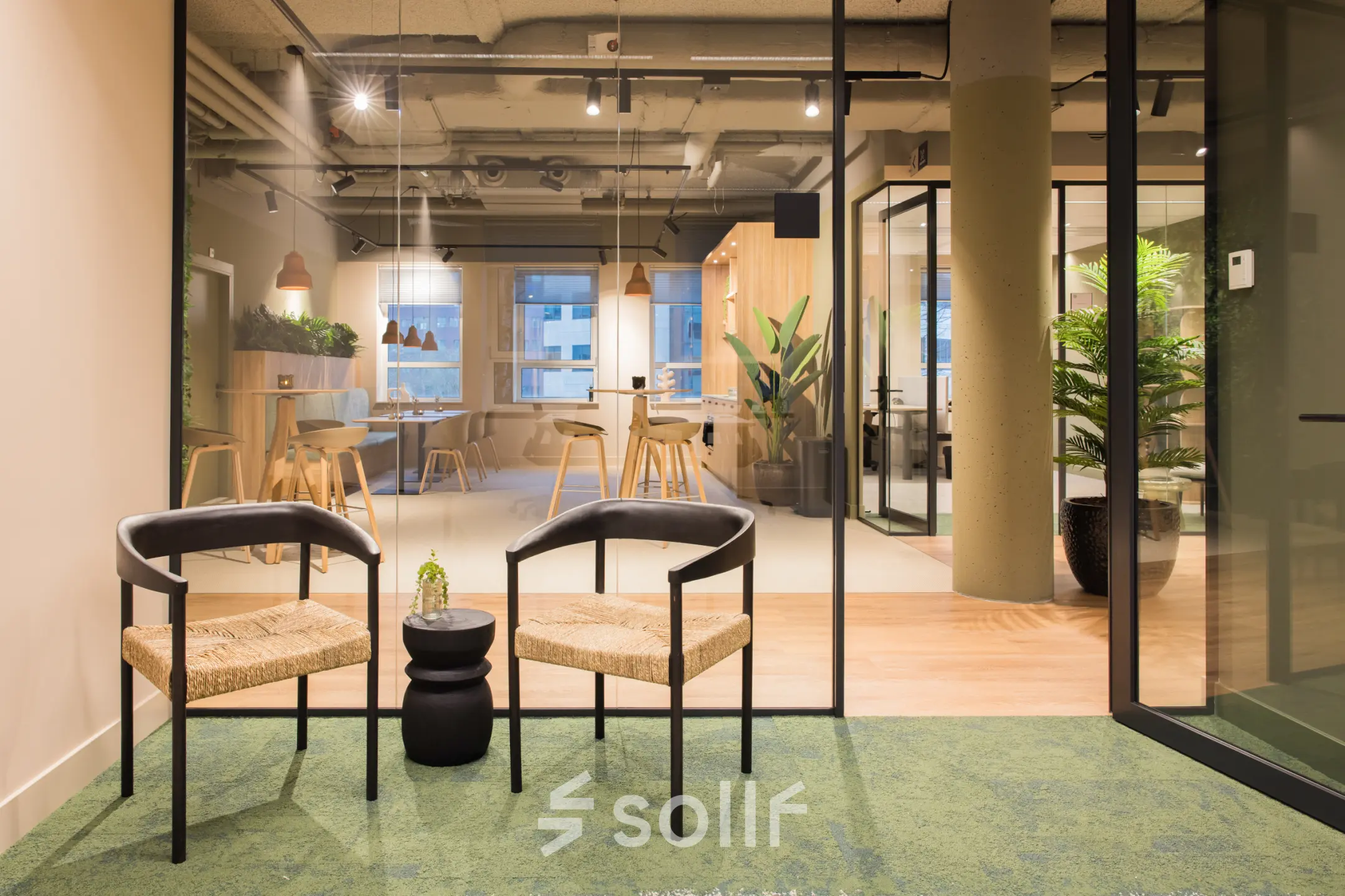 Modern office space in Amsterdam South East at Hullenbergweg 109-135, featuring a stylish interior with seating, glass partitions, and greenery, perfect for an office to rent.