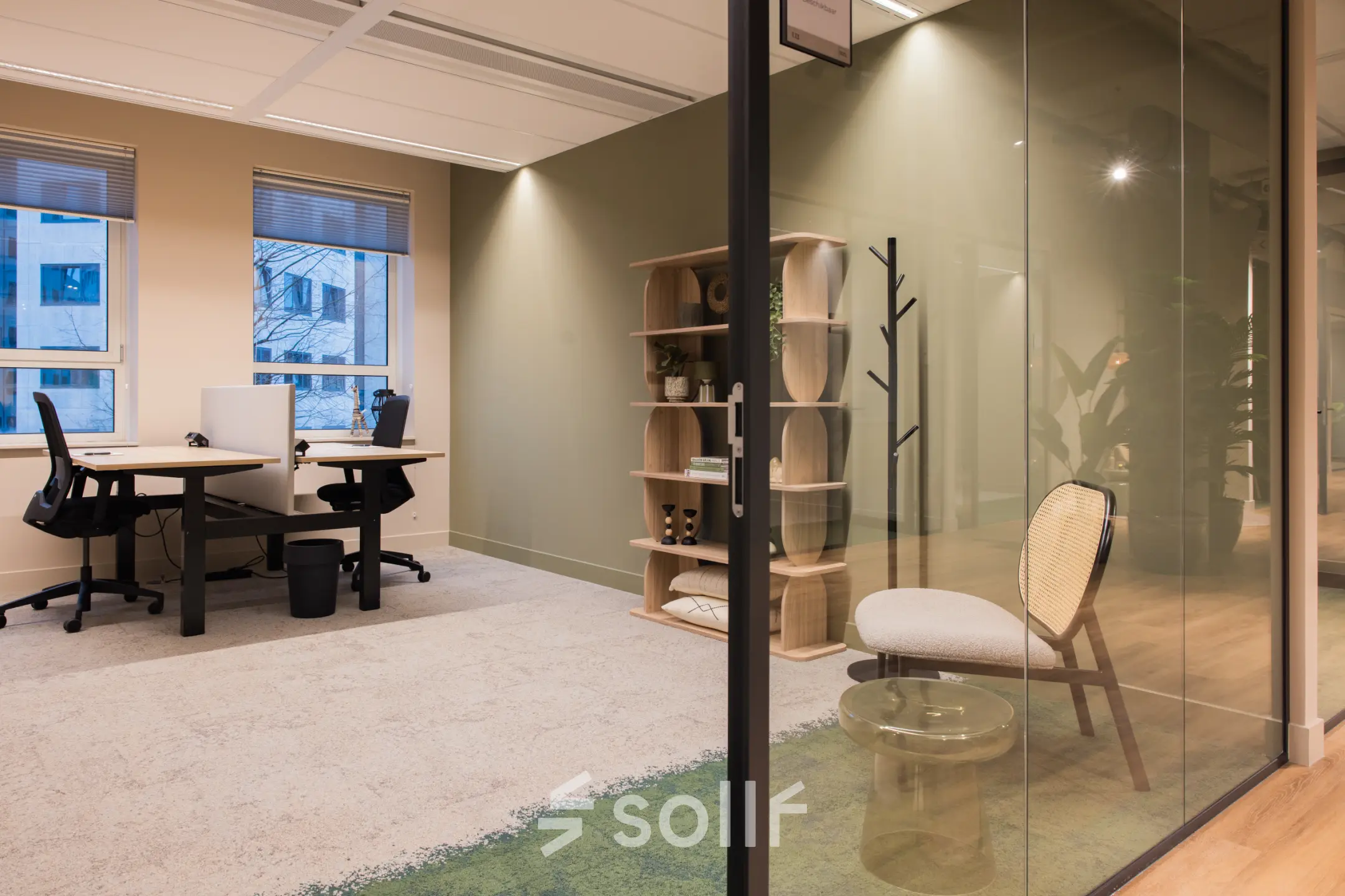 A modern, furnished office space at Hullenbergweg 109-135, Amsterdam South East, featuring a shared workspace with two desks and chairs, suitable for office space rental.