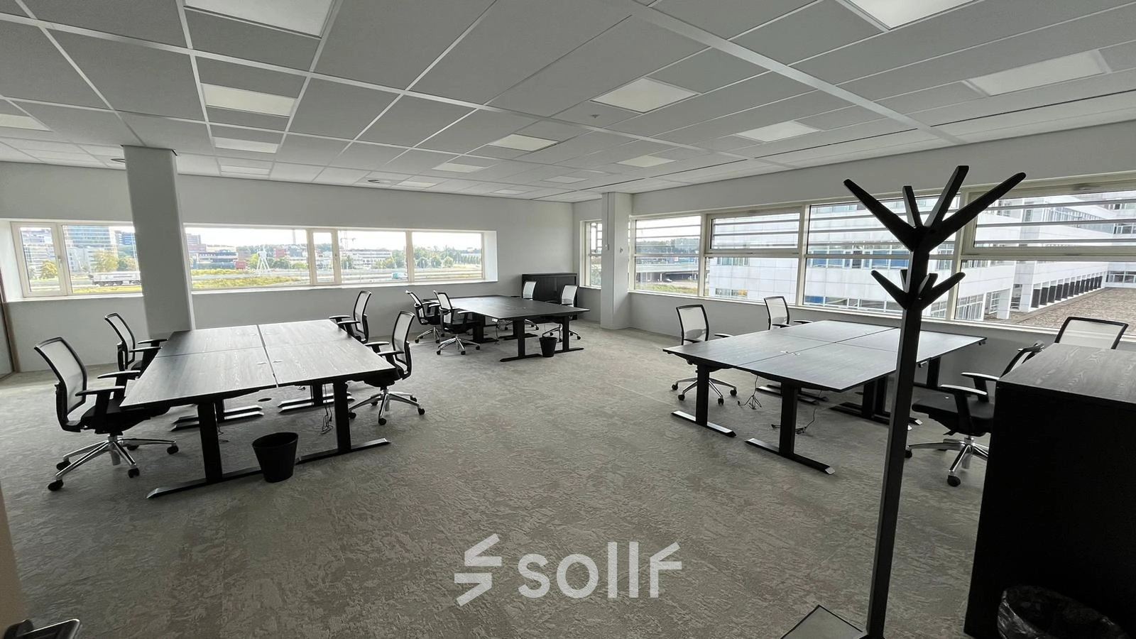 Spacious office at Laarderhoogtweg 7-19, Amsterdam South East, available for rent. Furnished with modern desks and chairs, ideal for collaborative work. Large windows offer ample natural light.