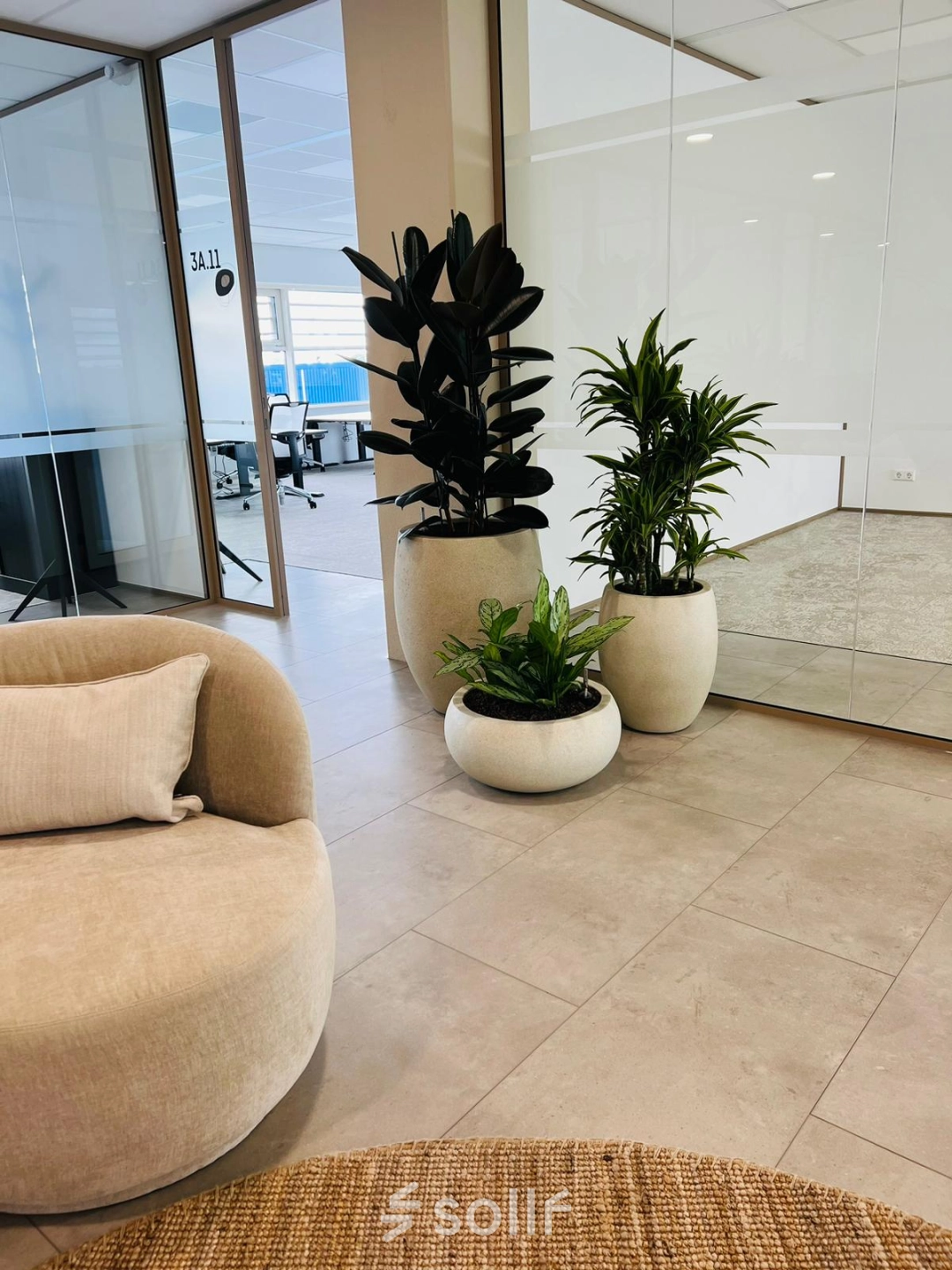 Modern office lobby at Laarderhoogtweg 7-19, Amsterdam South East, featuring stylish seating and indoor plants. Ideal office space rental opportunity.
