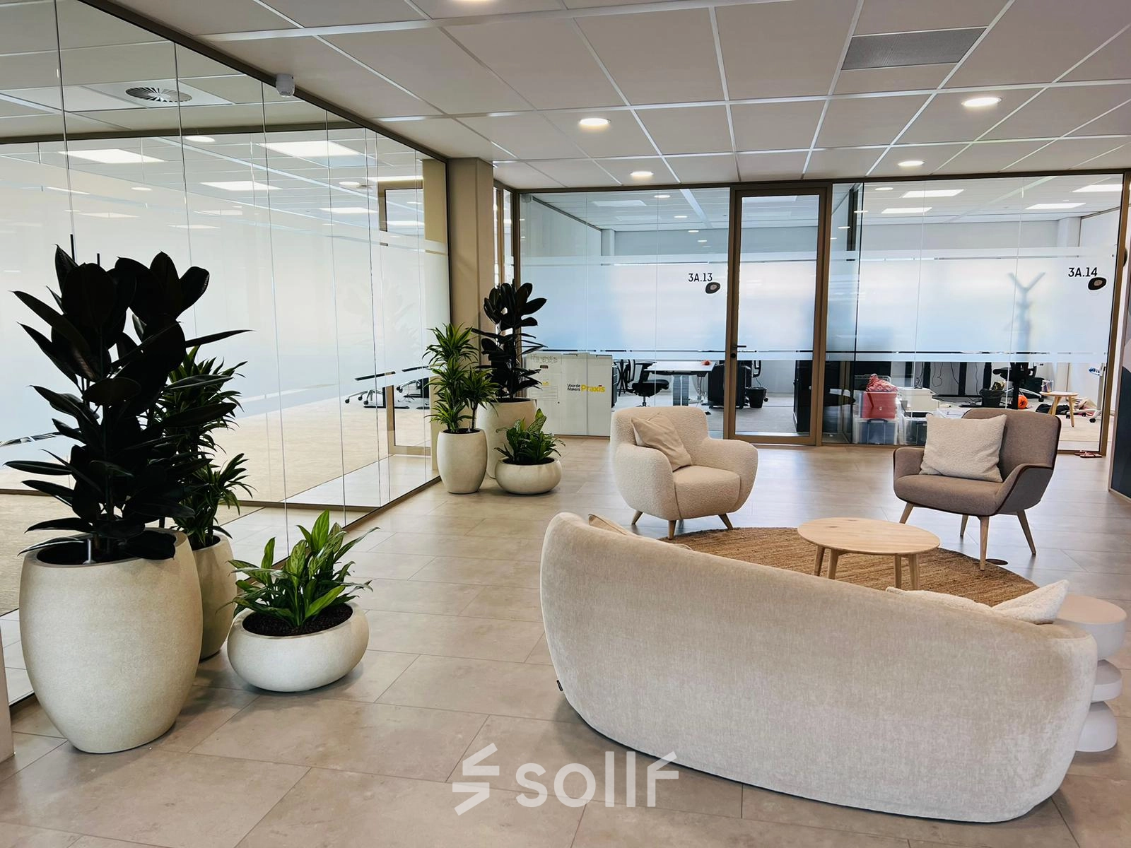 Stylish office space rental in Amsterdam South East with modern furnishings, including comfortable seating and greenery, ideal for meetings or collaborative work.