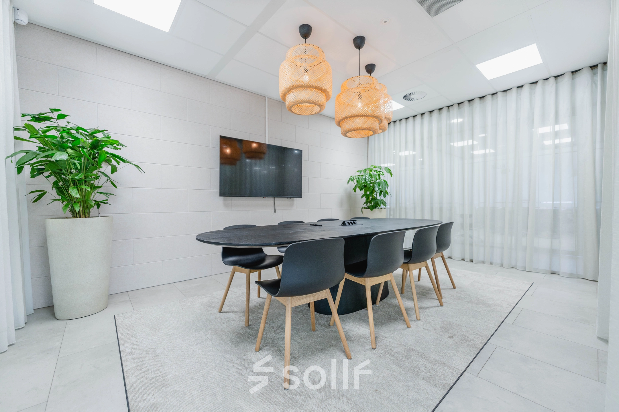 Modern conference room for office space rental at Laarderhoogtweg 7-19 in Amsterdam South East, featuring a large table, stylish chairs, and contemporary lighting.