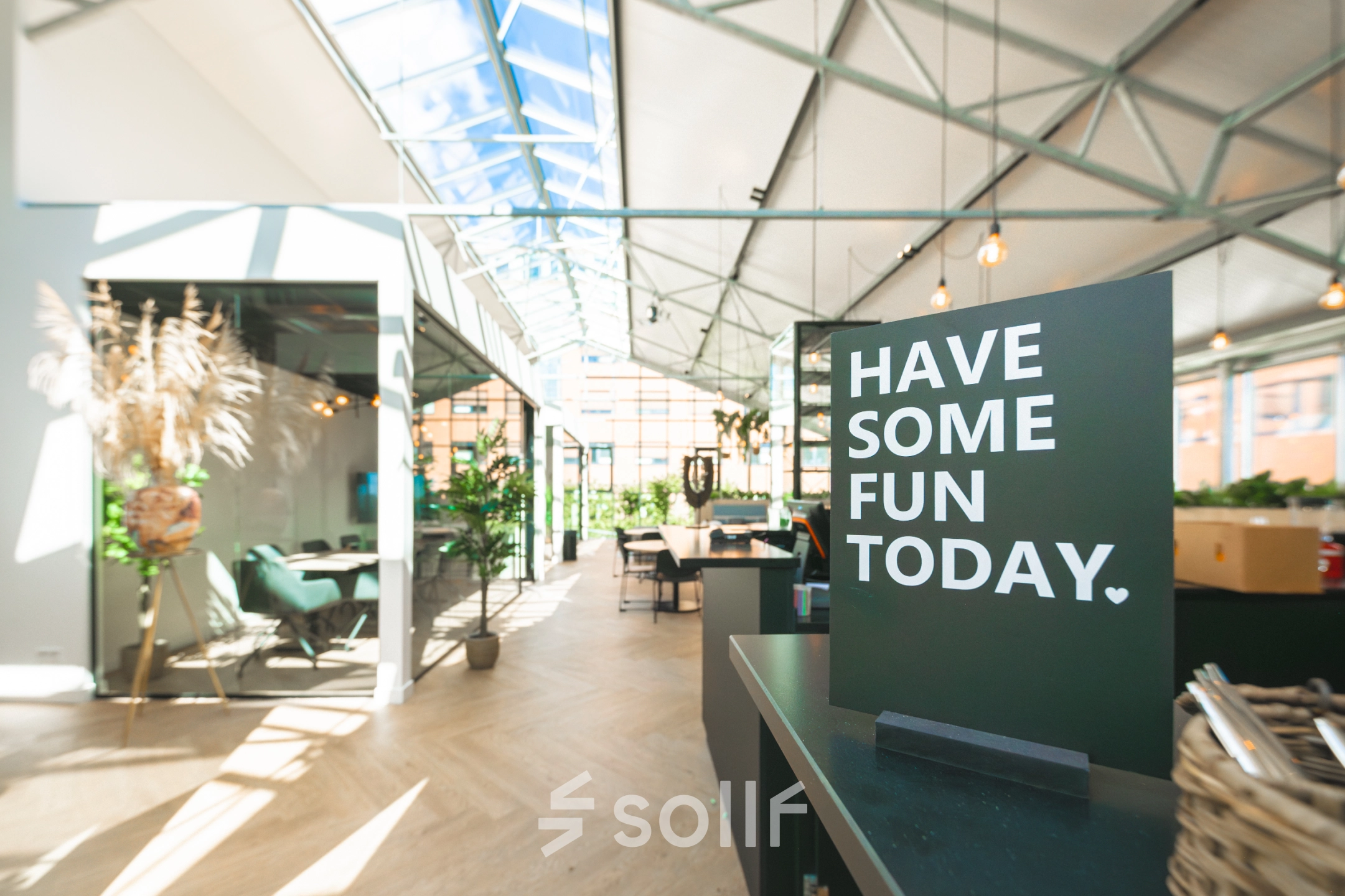 Bright, airy office space rental with glass roof, greenery, and modern furnishings at Luttenbergweg 8. Ideal office to rent in Amsterdam South East for productive work.