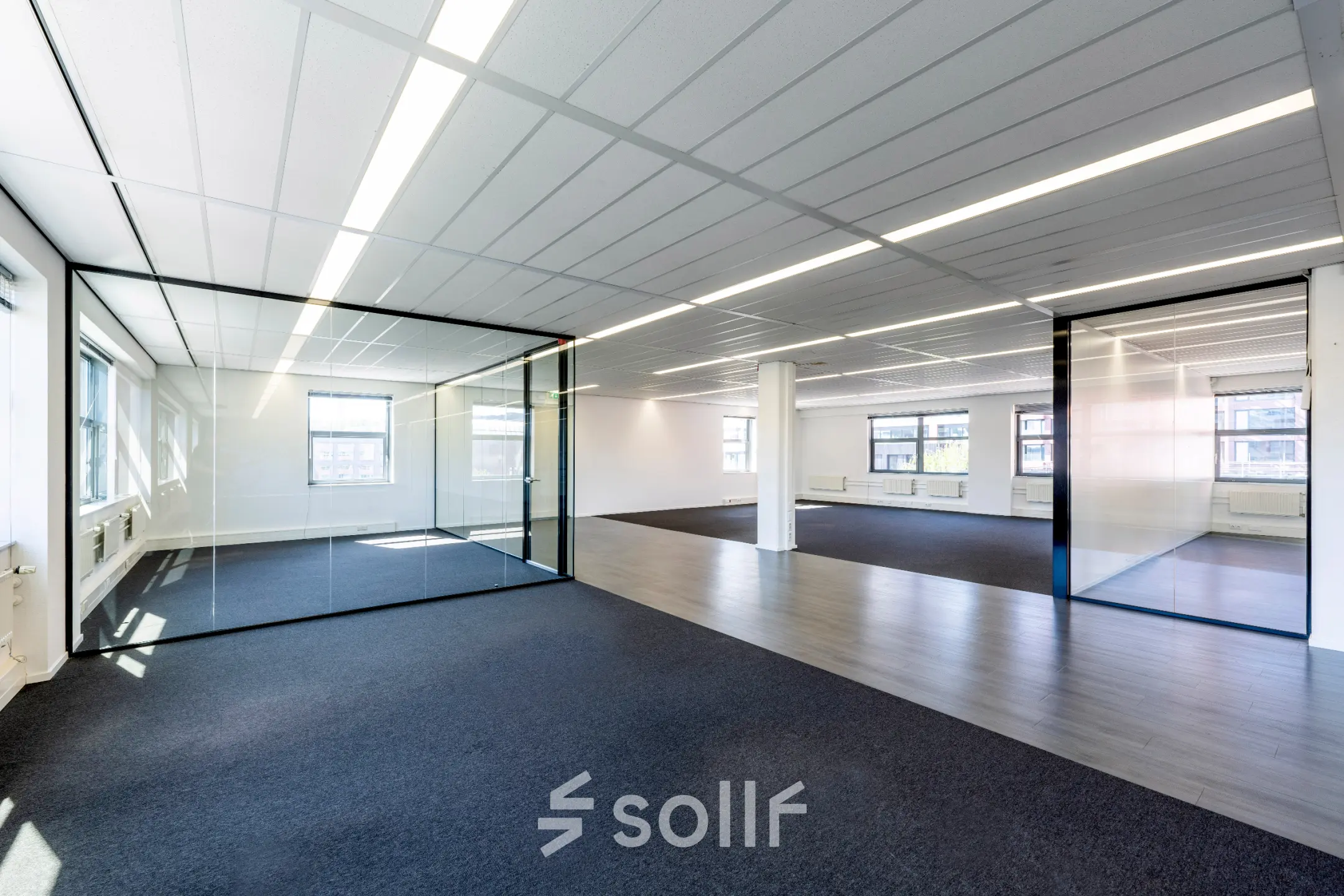 Spacious office to rent at Paasheuvelweg 20 20, in Amsterdam South East, featuring a large open floor plan with glass partitions and ample natural light.
