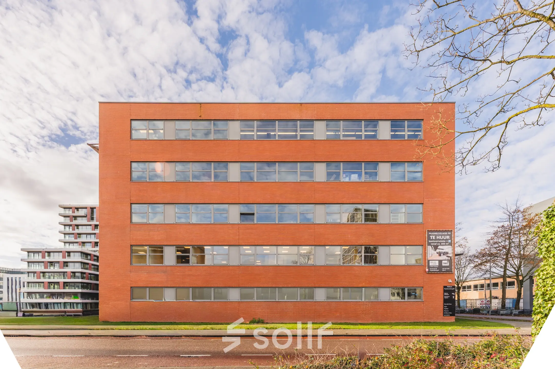 Exterior view of a brick office building at Paasheuvelweg 20, Amsterdam South East, highlighting available office space rental options.