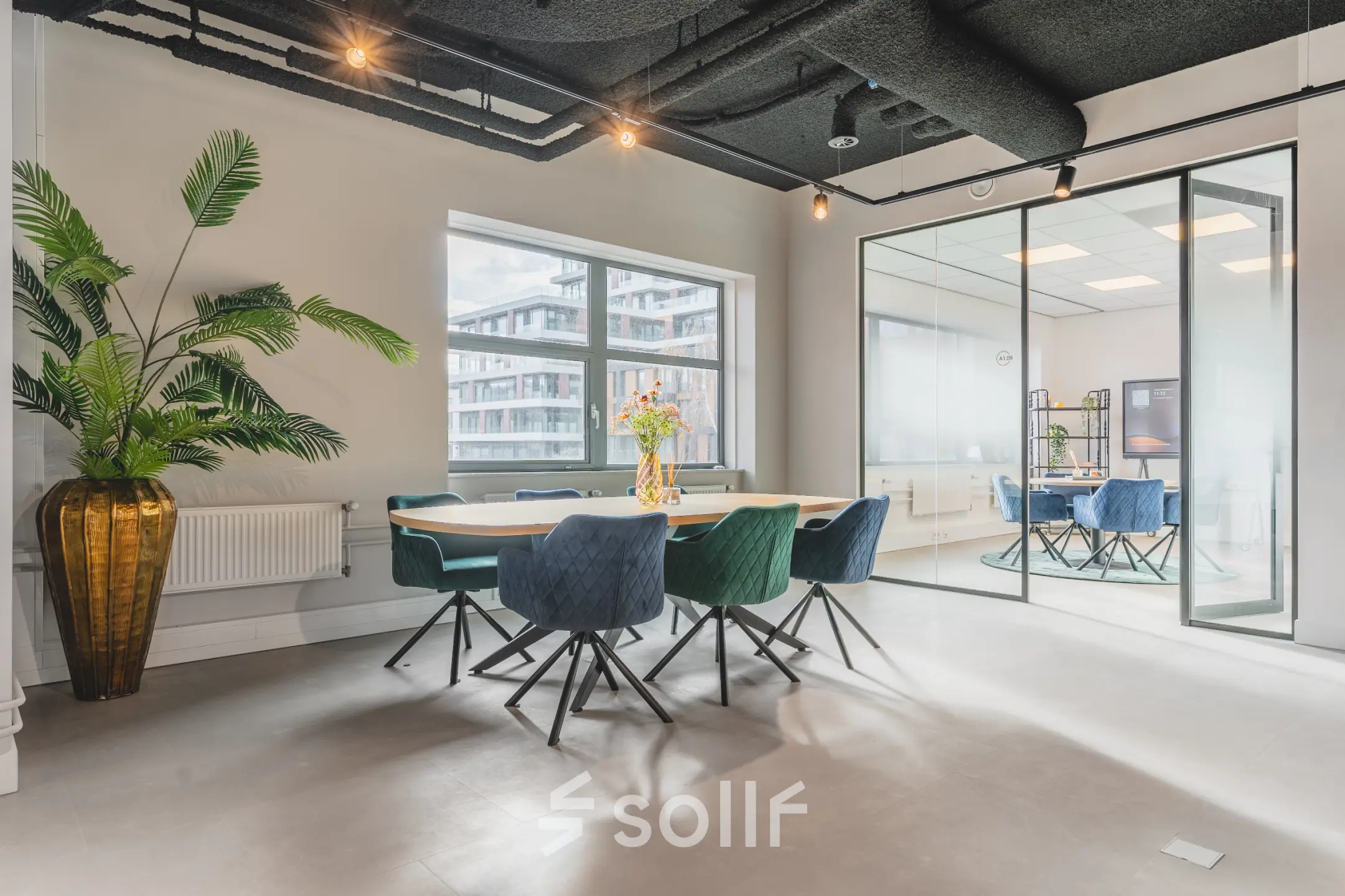 Bright office space with modern furnishings and a large conference table, located at Paasheuvelweg 20, Amsterdam South East, ideal for office space rental.