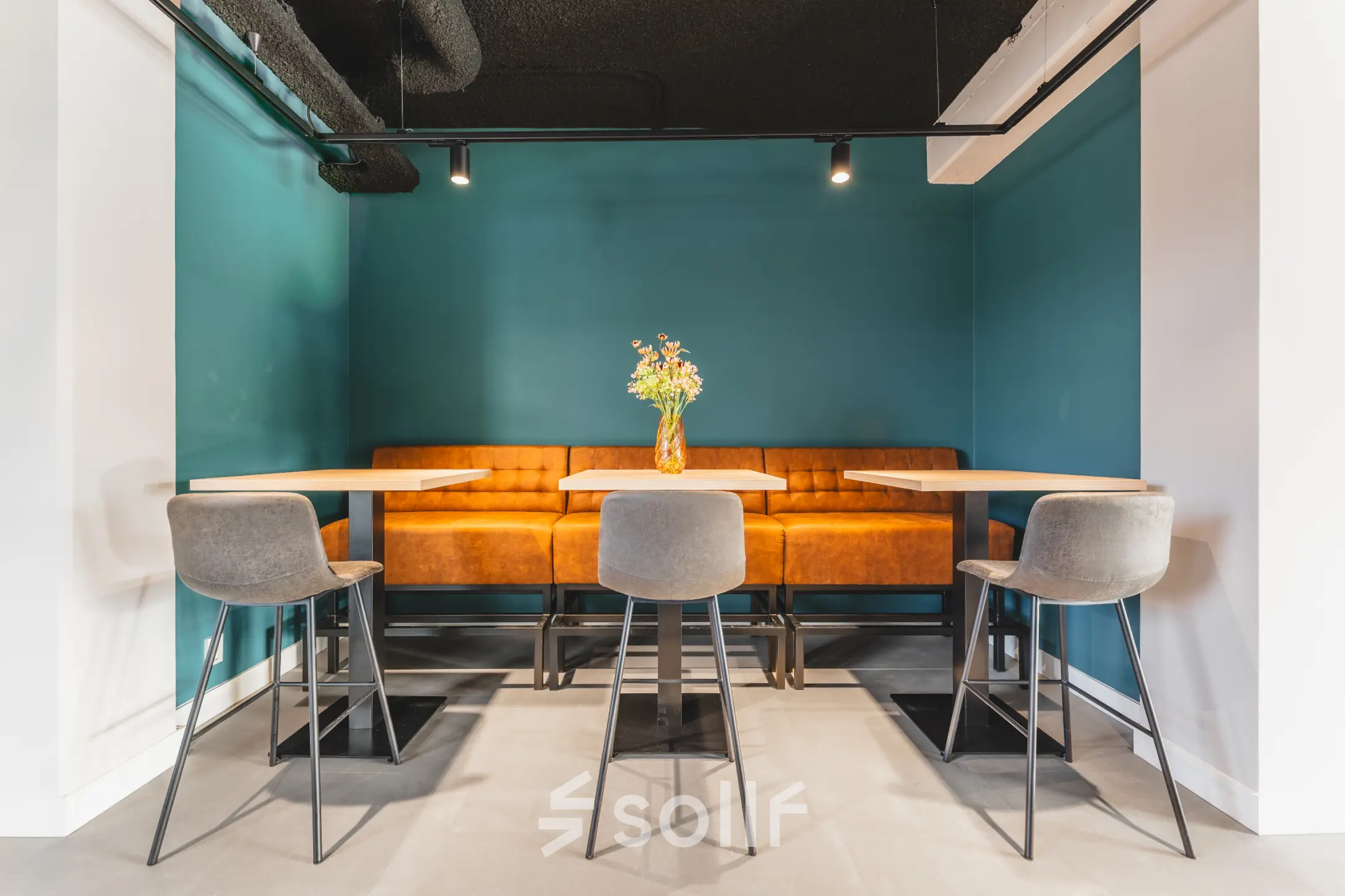 Cozy office space at Paasheuvelweg 20, Amsterdam South East, featuring a comfortable seating area with tables and chairs in a modern design, ideal for rent office space.