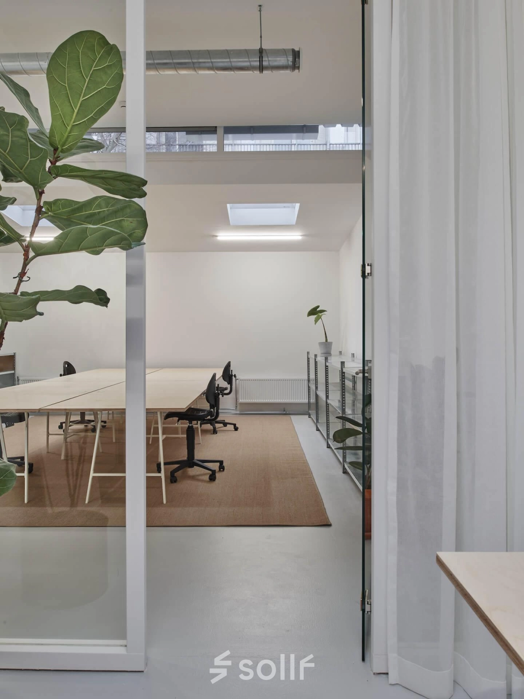 Modern office space with minimalist design at Hondiusstraat 7H, Amsterdam West. Features include sleek desks, contemporary chairs, and natural lighting, ideal for office space rental.