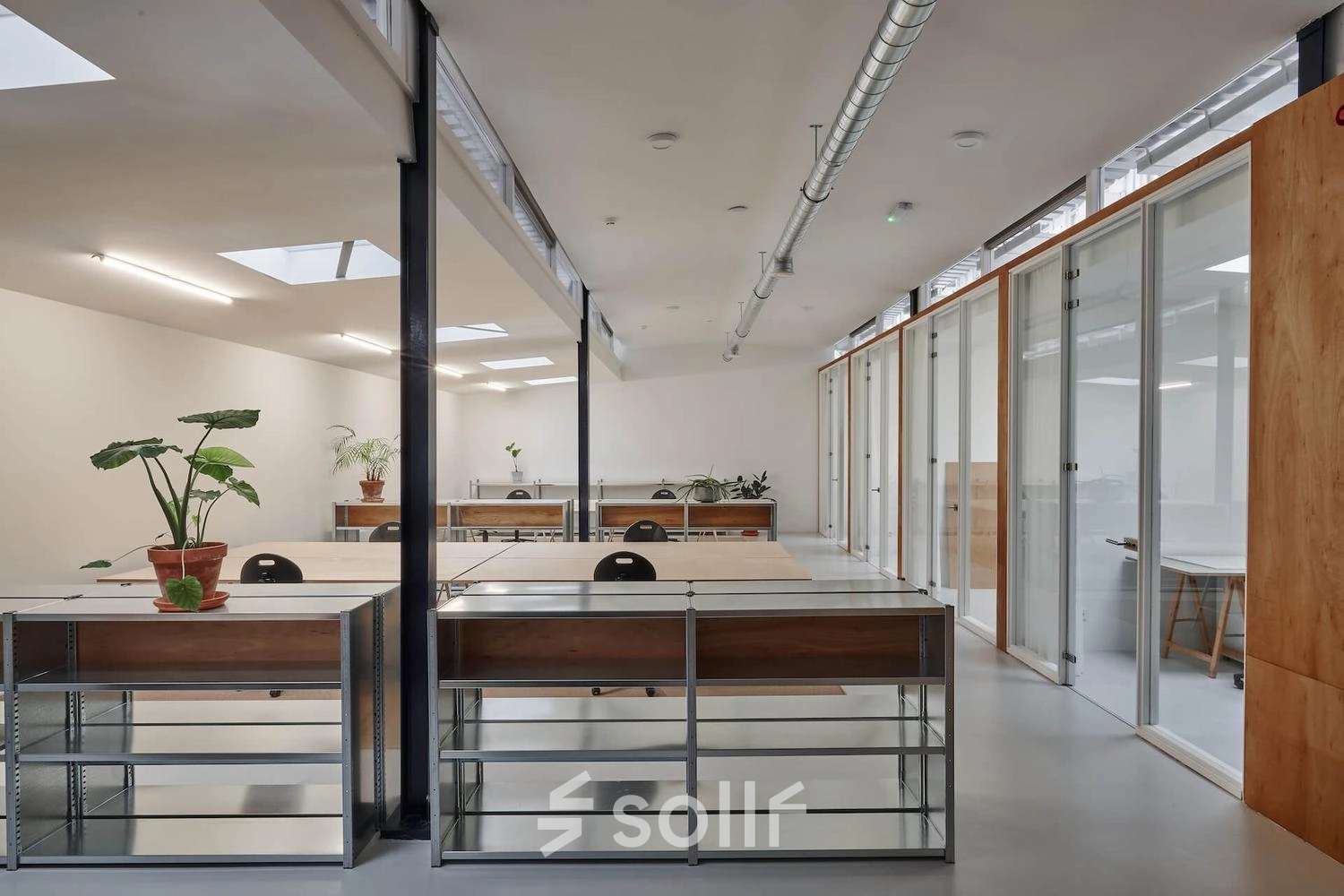 Bright office interior at Hondiusstraat 7H, Amsterdam West, showcasing modern, airy workspaces with sleek desks and large windows, ideal for office space rental.