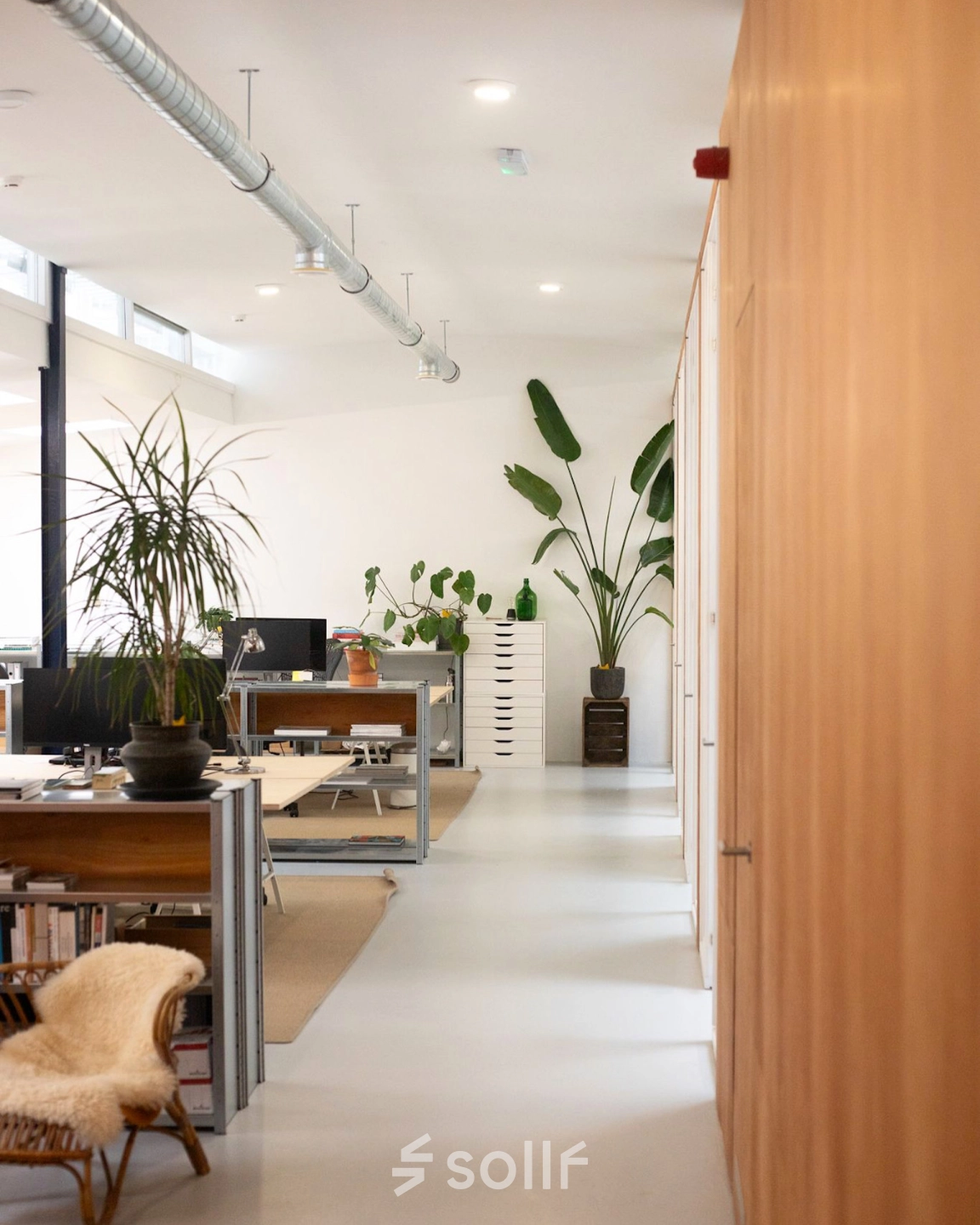 Modern office space at Hondiusstraat 7H, Amsterdam West, featuring open workstations with sleek furnishings and ample natural light, ideal for office space rental.