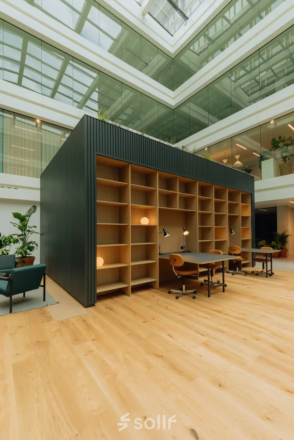 Modern office space with wooden floors featuring open shelving and desks for rent at Kon. Wilhelminaplein 4, Amsterdam West.