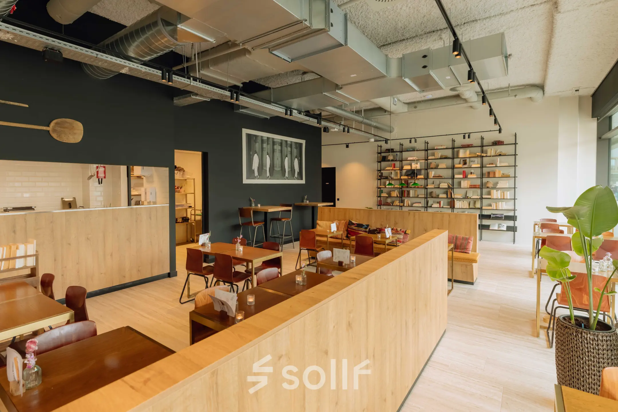 Spacious office to rent in Amsterdam West with modern furnishings, wooden accents, and an organized layout, ideal for collaborative workspaces.