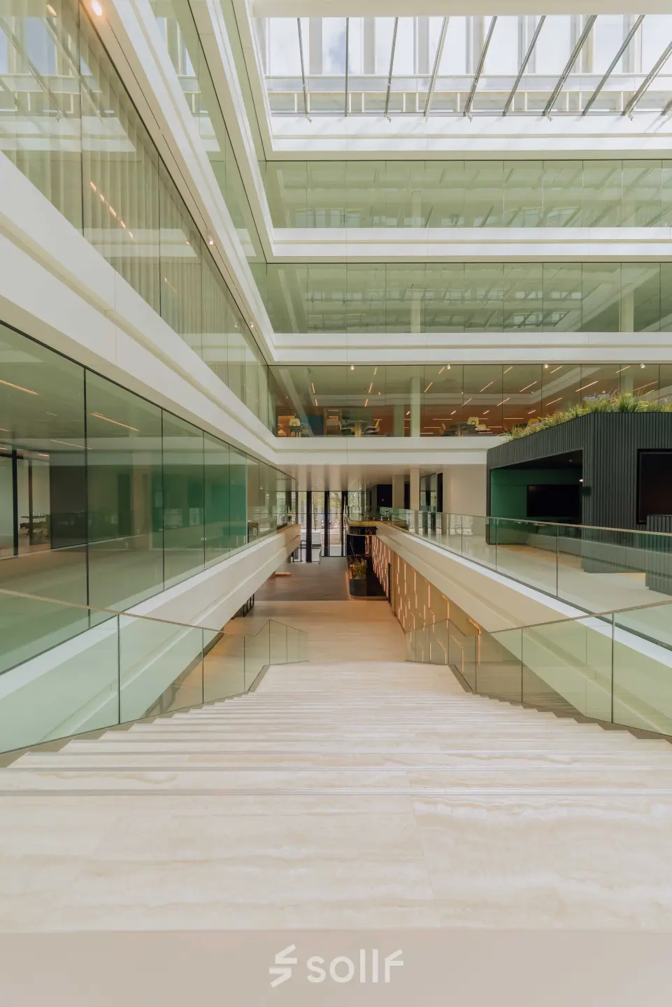 Spacious interior with modern glass architecture at Kon. Wilhelminaplein 4, Amsterdam West, perfect for rent office space. Bright and open with sleek design, offering potential for versatile office space rental.