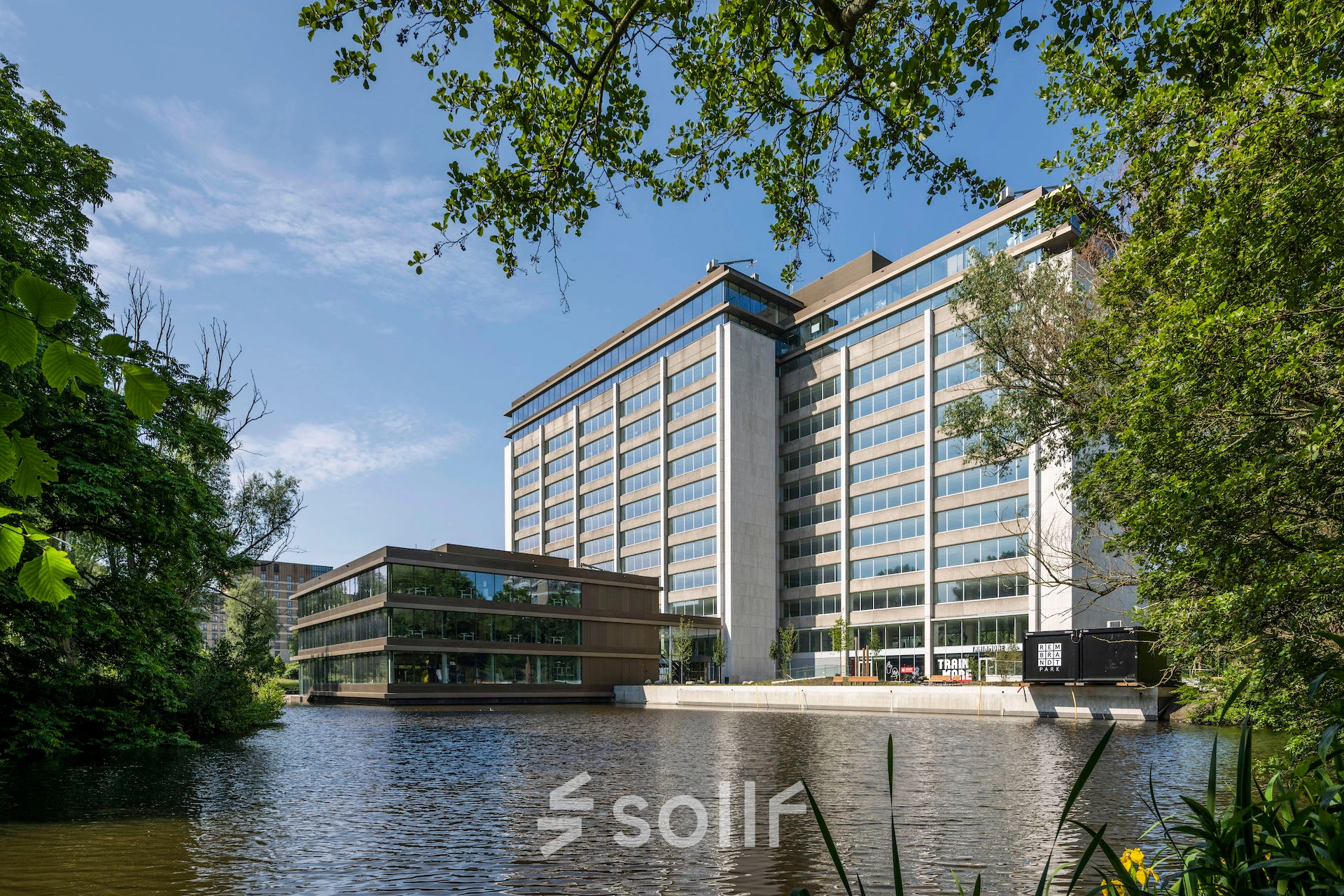 Modern office building at Nachtwachtlaan 20, Amsterdam West, featuring large windows and surrounded by greenery, ideal for office space rental.