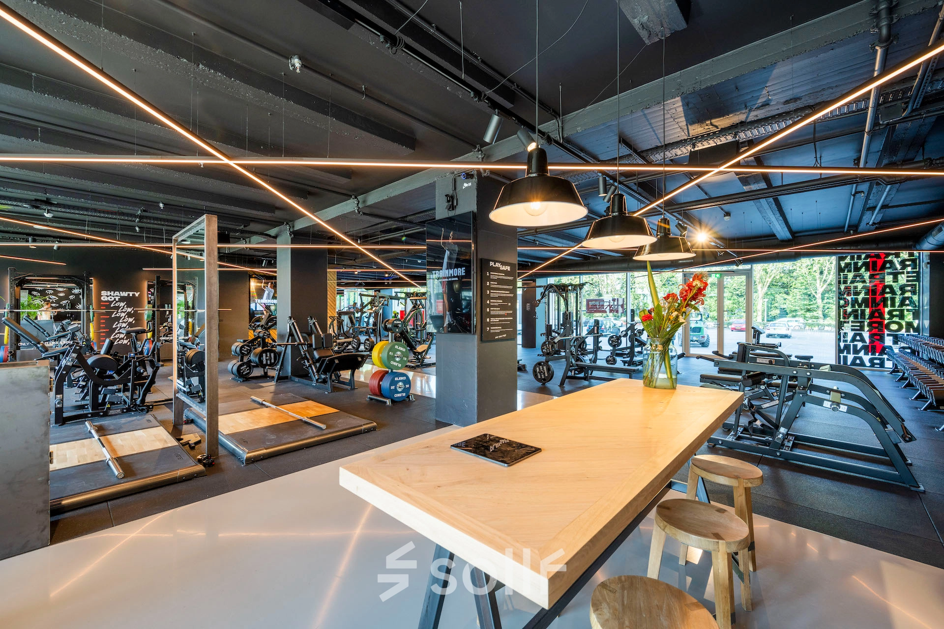 Modern gym area in an office space with various fitness equipment. Ideal for office space rental to encourage employee wellness at Nachtwachtlaan 20, Amsterdam West.