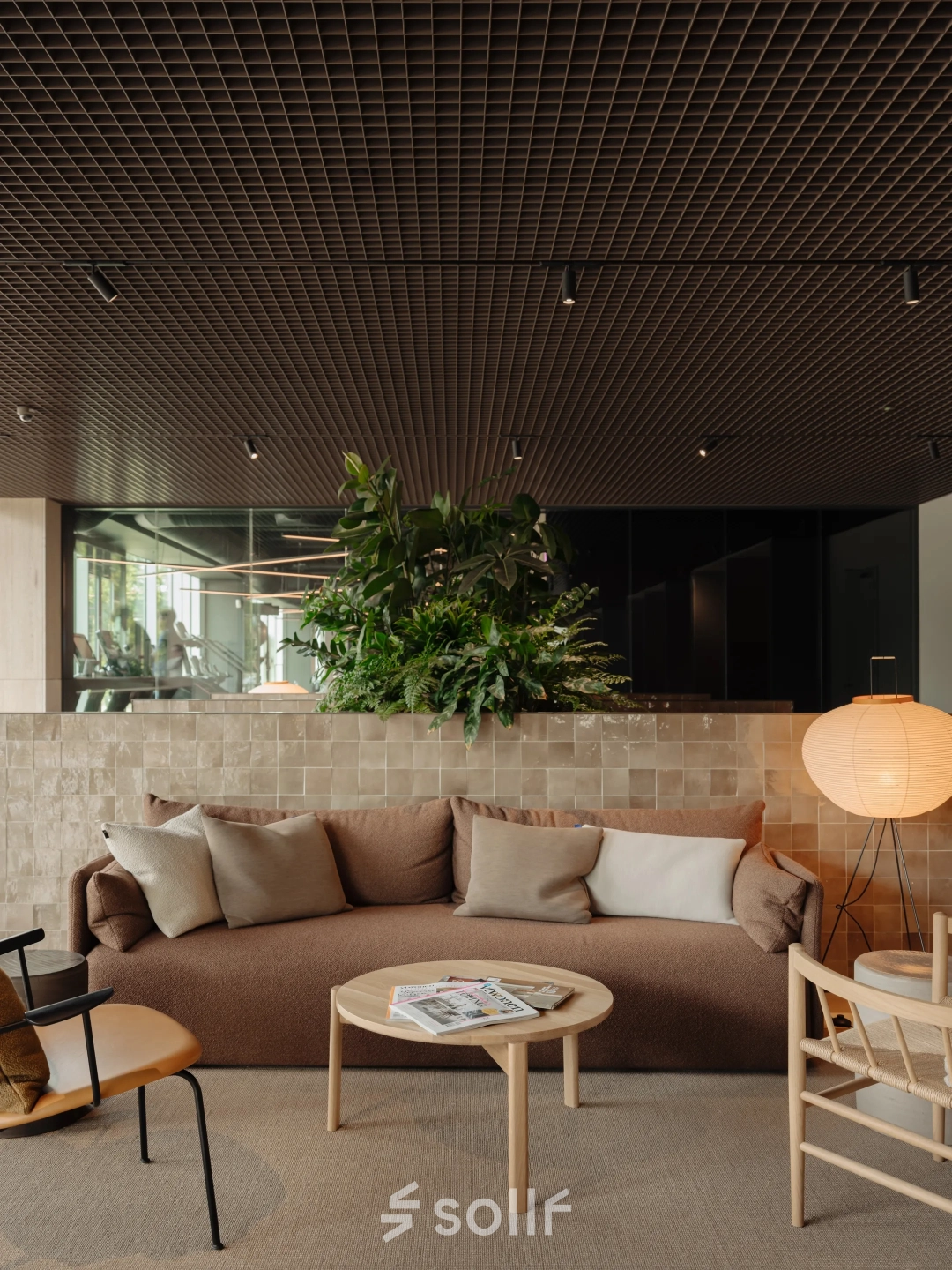 Cozy and modern lounge area with seating and table, ideal for office space rental at Nachtwachtlaan 20, Amsterdam West.