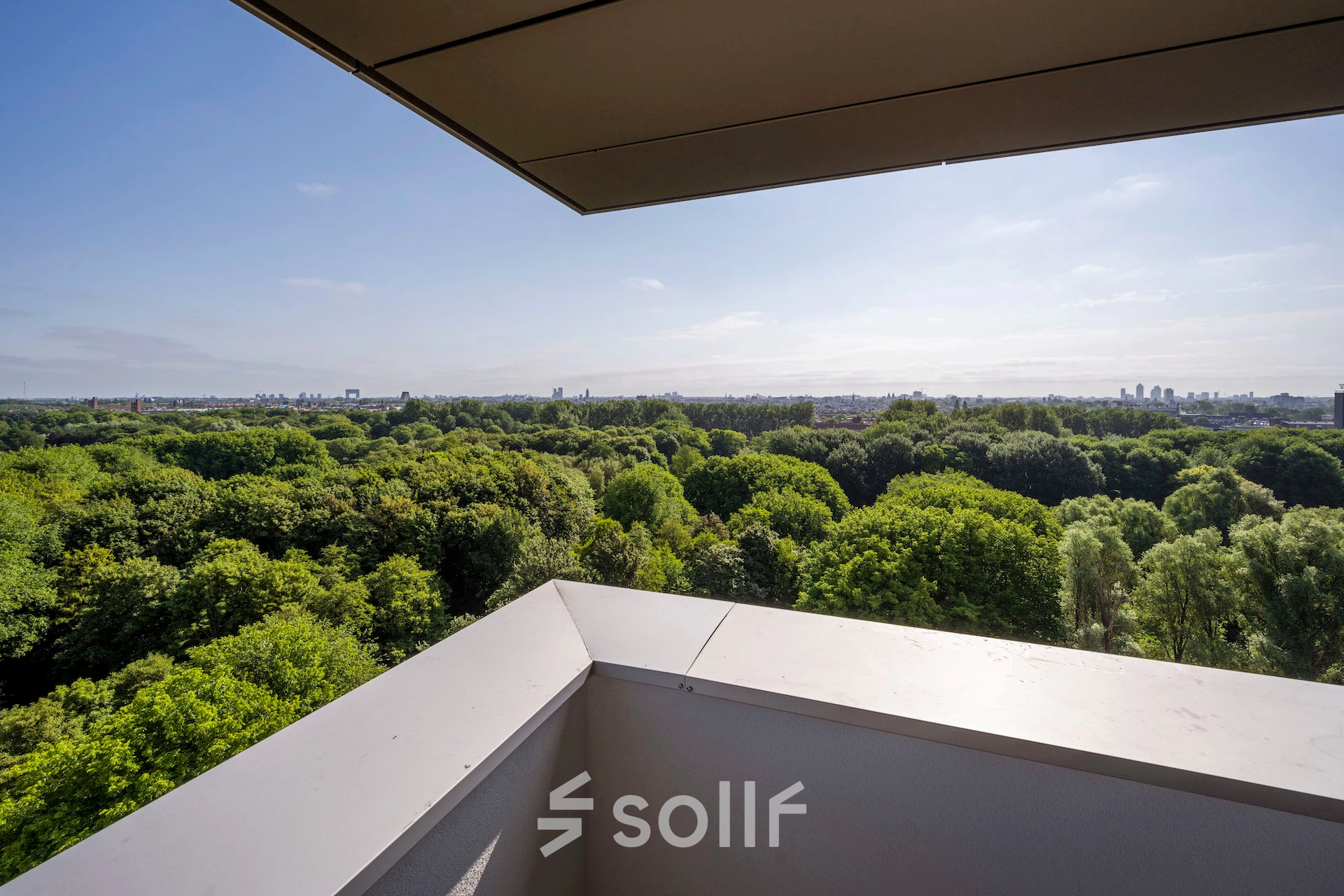 View from the office to rent at Nachtwachtlaan 20, Amsterdam West, overlooking a lush, green landscape.