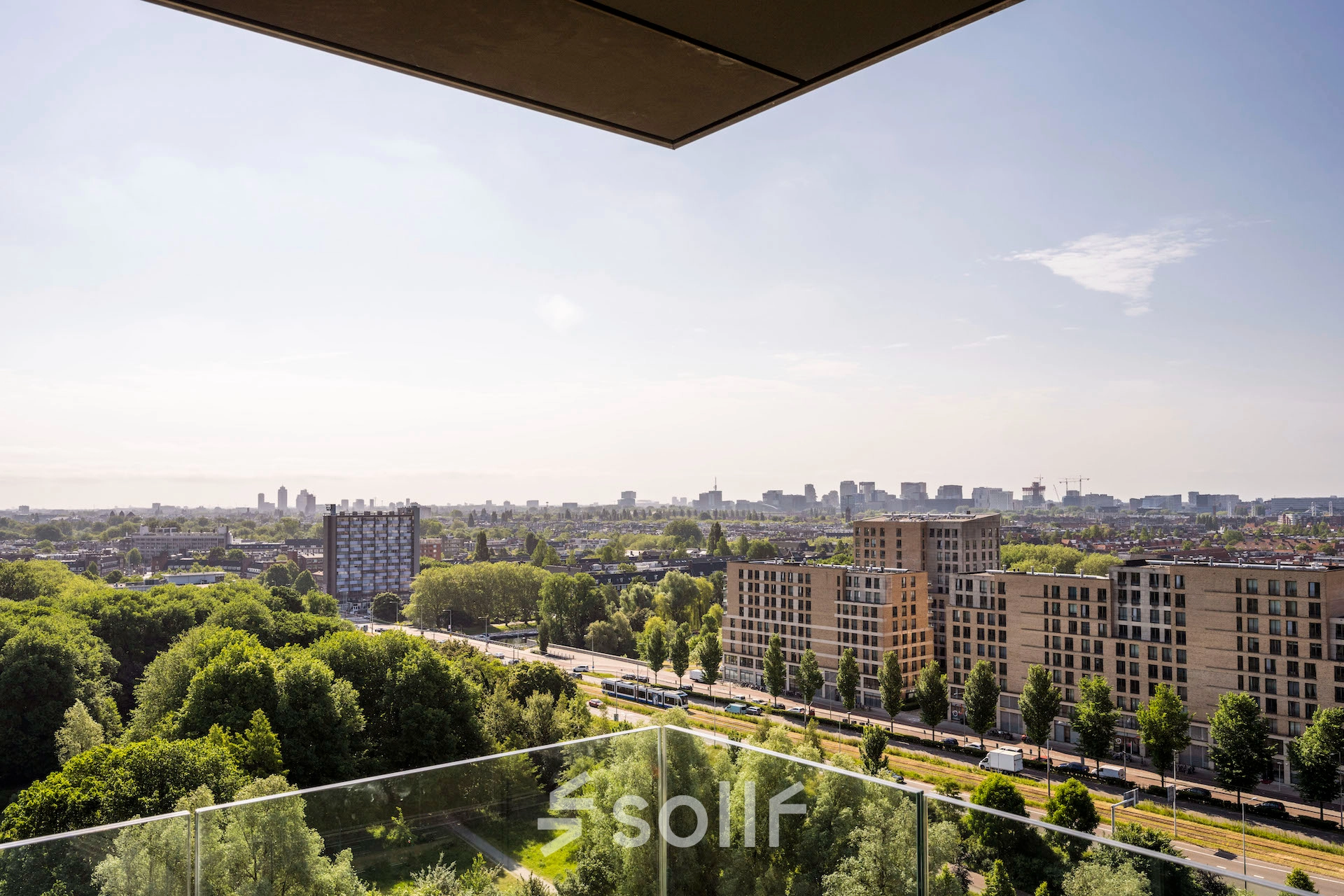 View from an office to rent at Nachtwachtlaan 20, overlooking the city and green areas in Amsterdam West.