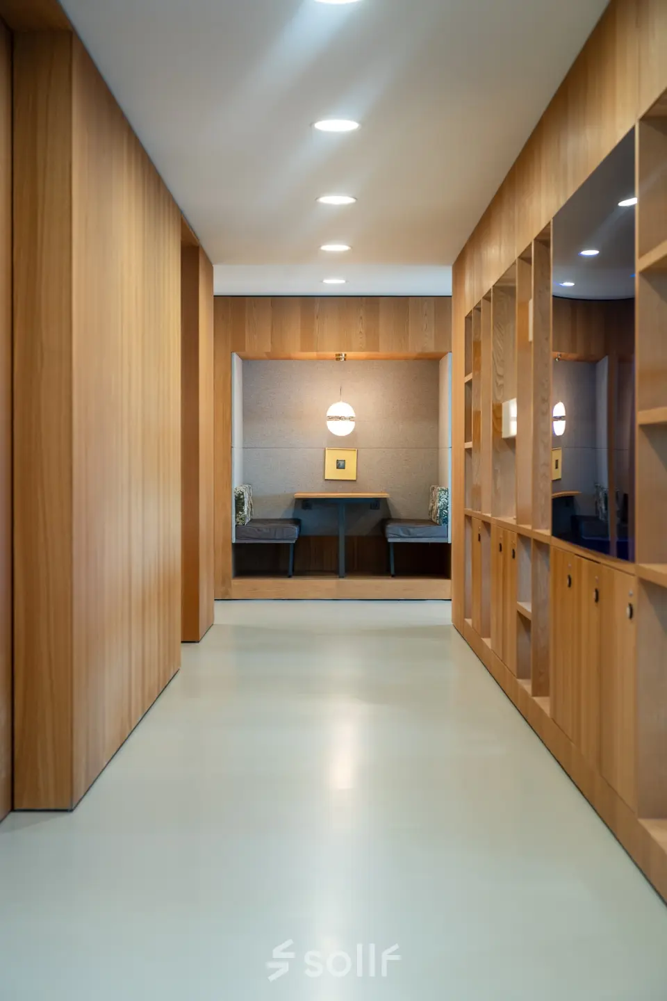 Modern hallway at Barbara Strozzilaan 101, Amsterdam Zuidas, featuring sleek wood paneling and built-in storage, ideal for office space rental.