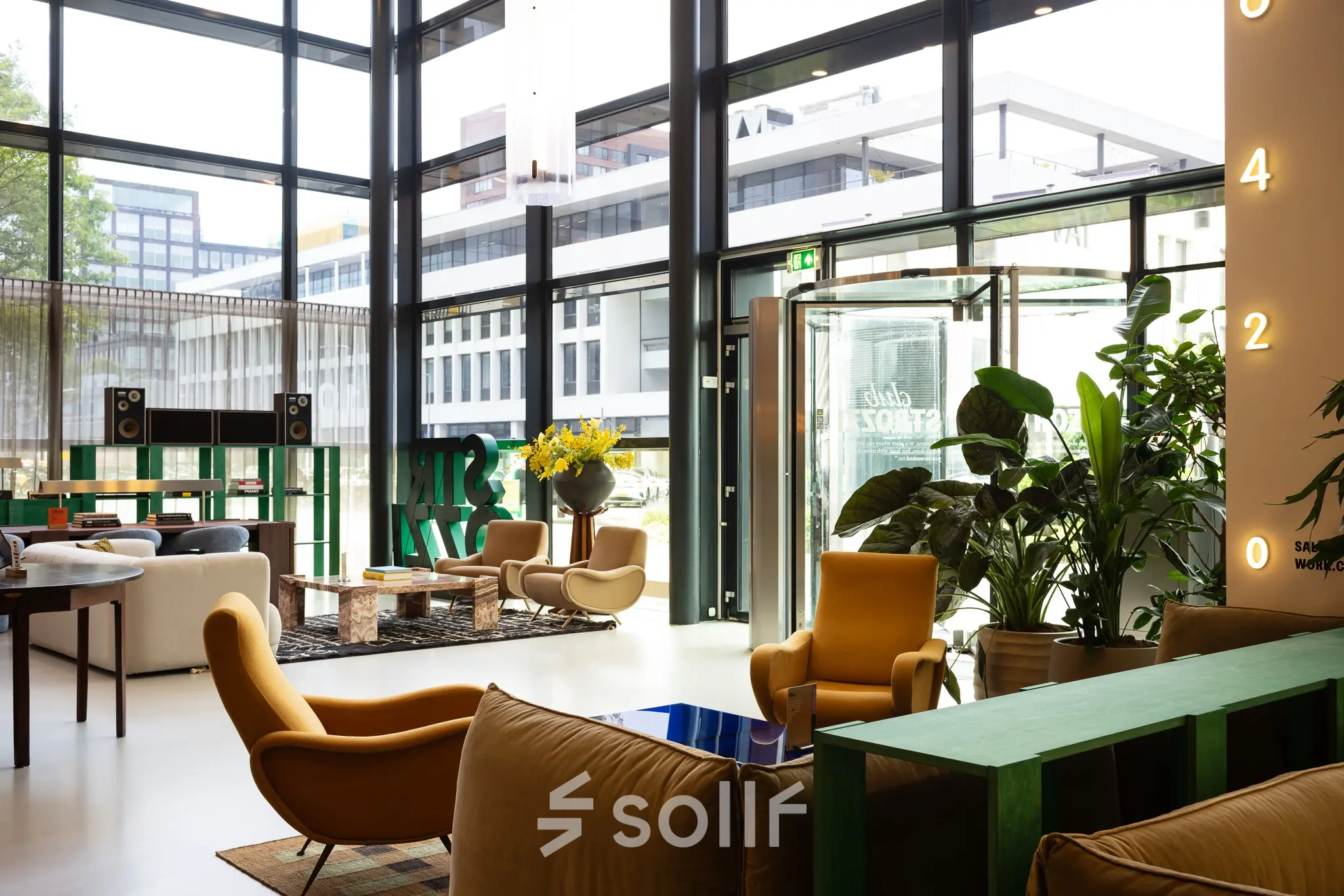 Spacious and well-lit office interior at Barbara Strozzilaan 101 in Amsterdam Zuidas, featuring modern furniture and large windows, ideal for office space rental.