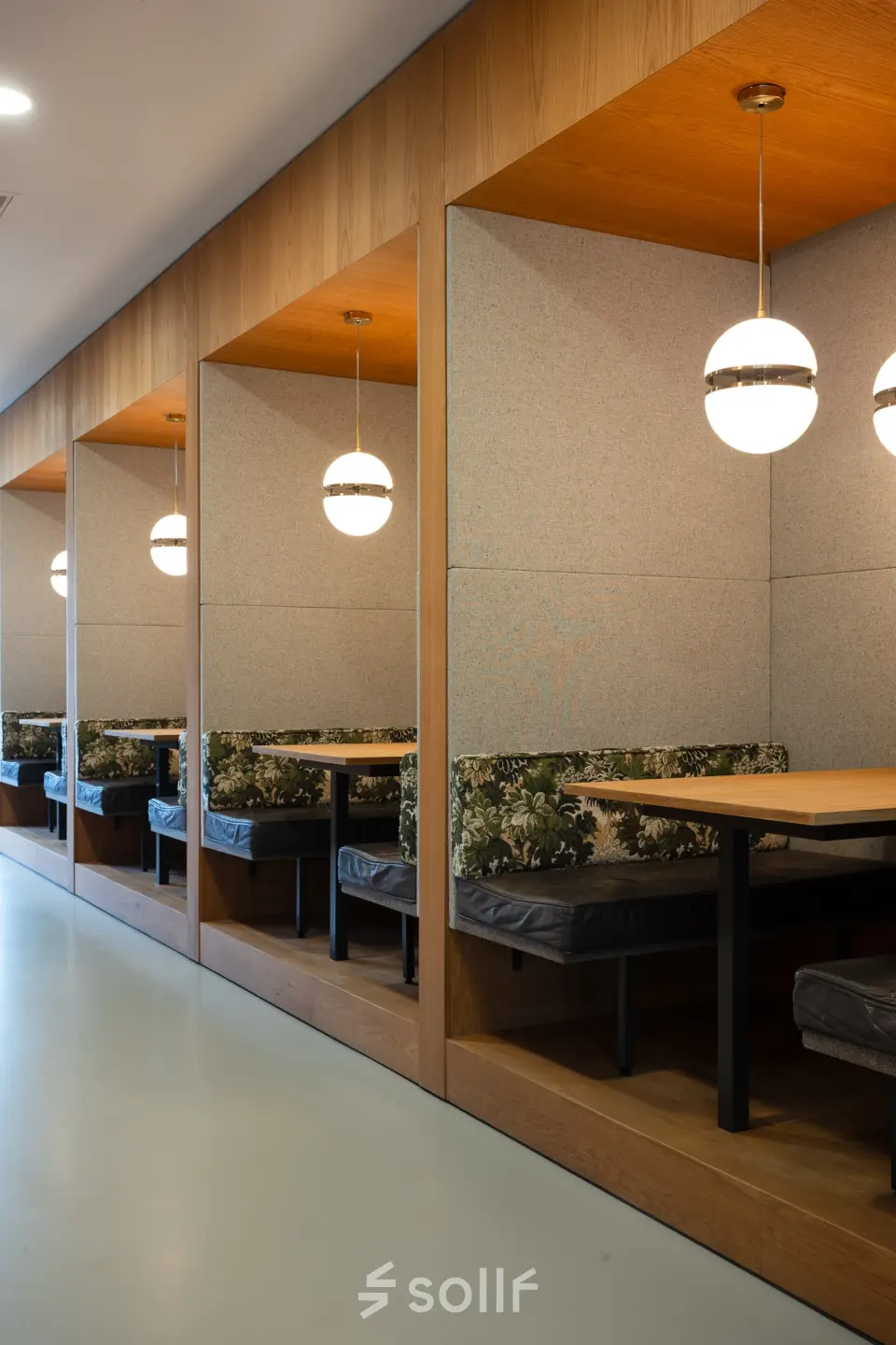 Cozy furnished workspace at Barbara Strozzilaan 101 in Amsterdam Zuidas featuring stylish booths for collaborative or independent work, ideal for office space rental.