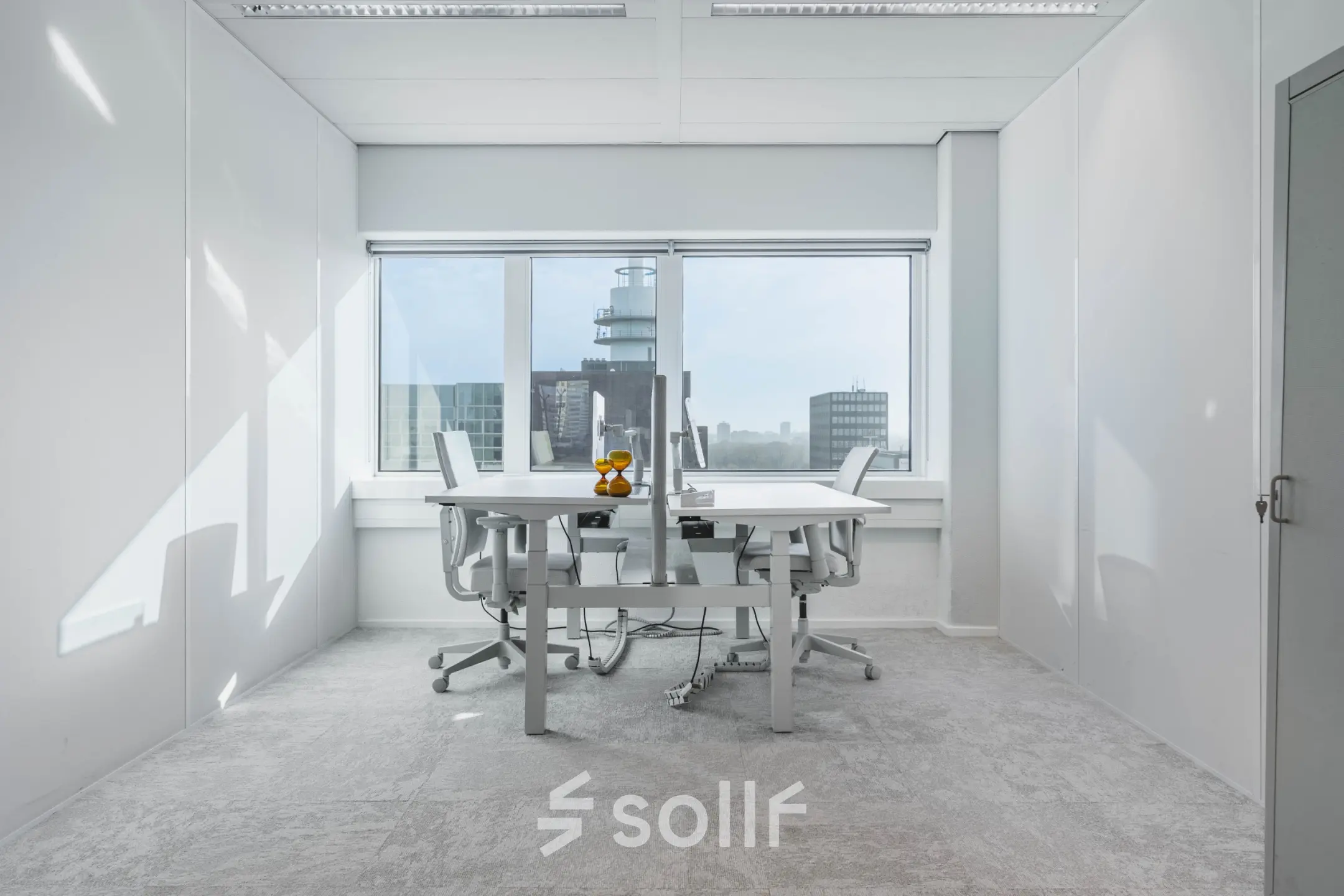 Bright office space at Barbara Strozzilaan 101, Amsterdam Zuidas, featuring large windows with a city view and modern furniture. Ideal for those seeking office space rental in a vibrant location.