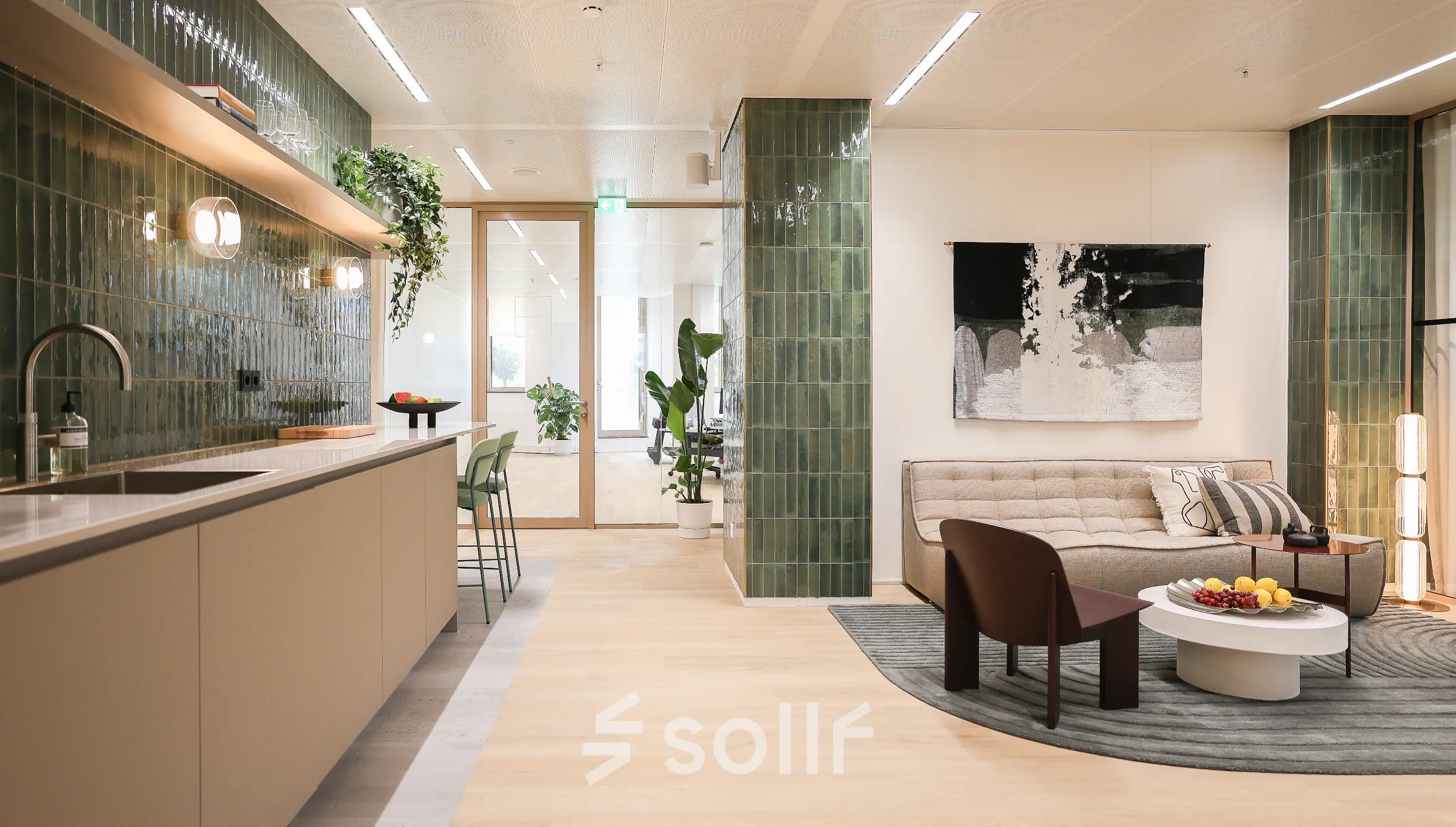Stylish office lounge in Amsterdam Zuidas at Beethovenstraat 503, featuring modern furniture and a kitchenette, perfect for office space rental. Ideal setting for informal meetings or relaxing breaks.