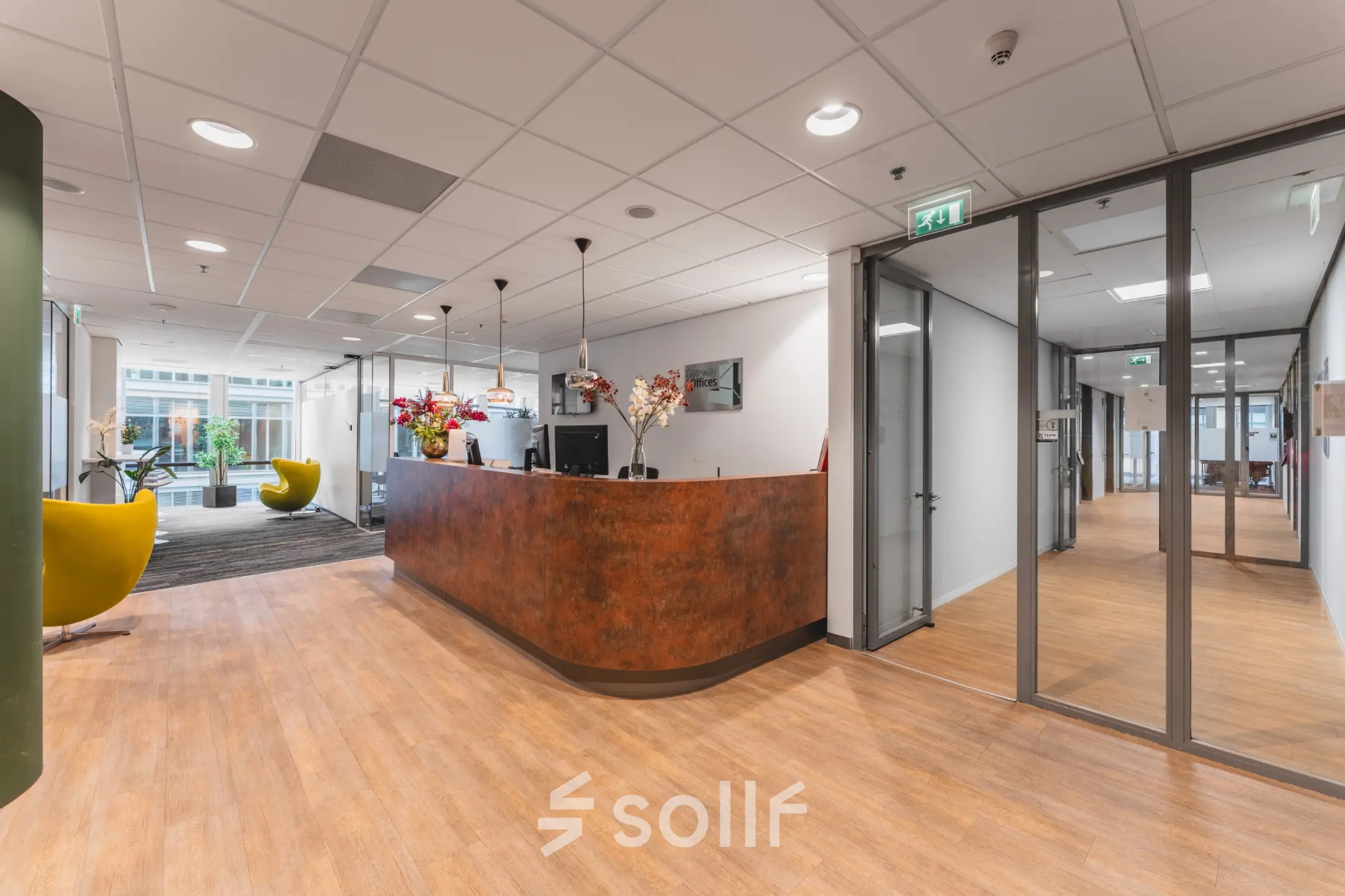 Spacious office reception at Claude Debussylaan 10, features modern furniture and large windows, ideal for office space rental in Amsterdam Zuidas.