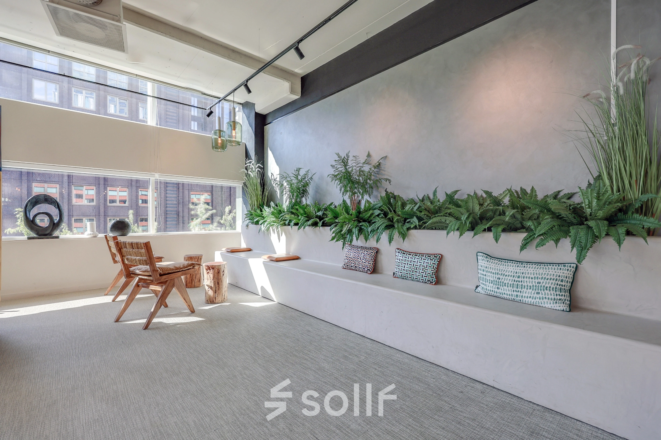Bright, modern office space rental at Gustav Mahlerlaan 308, Amsterdam Zuidas, featuring a stylish, furnished interior with seating and greenery.