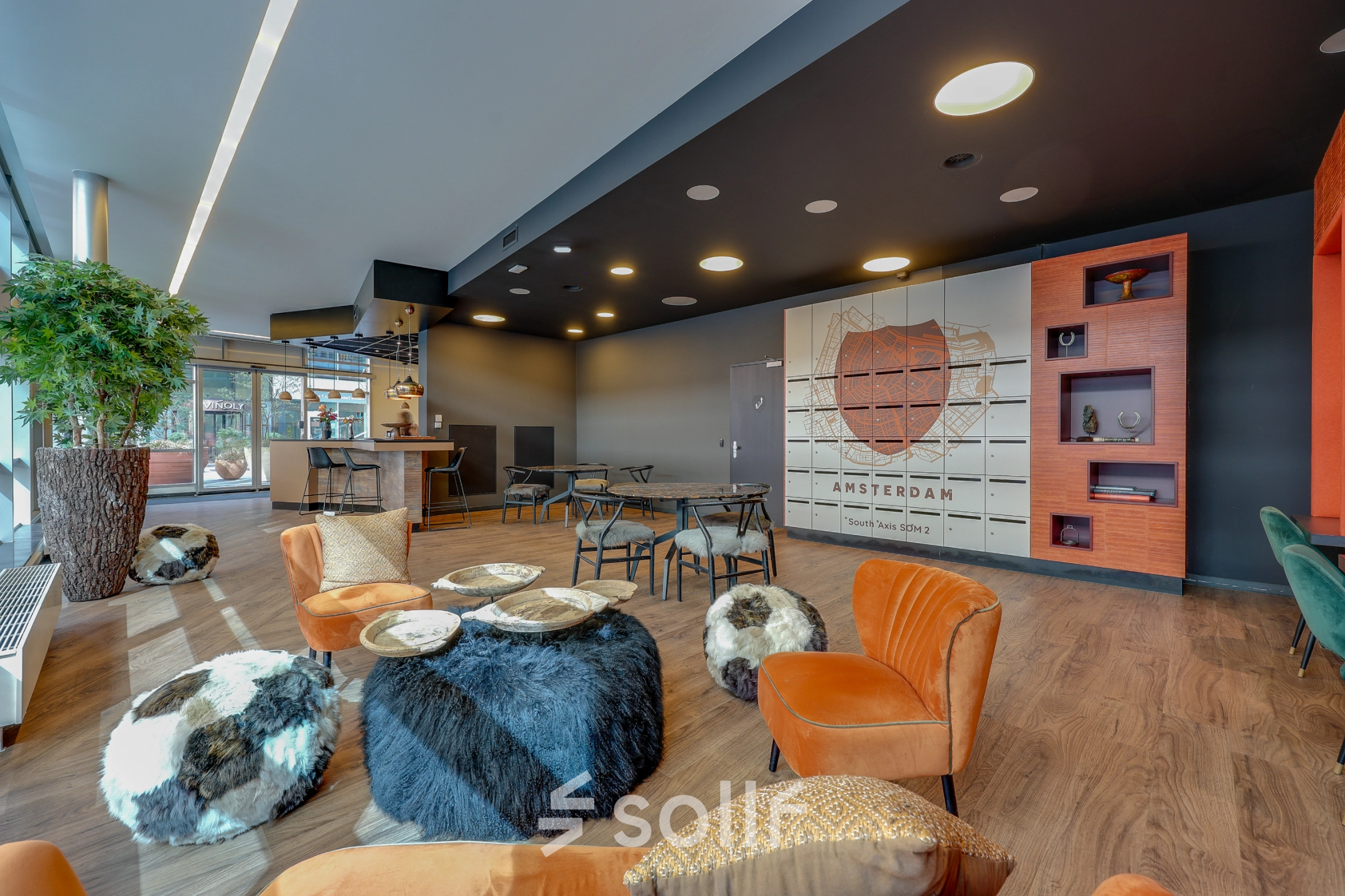 Modern furnished office space rental with cozy seating and decor at Gustav Mahlerlaan 308, Amsterdam Zuidas.